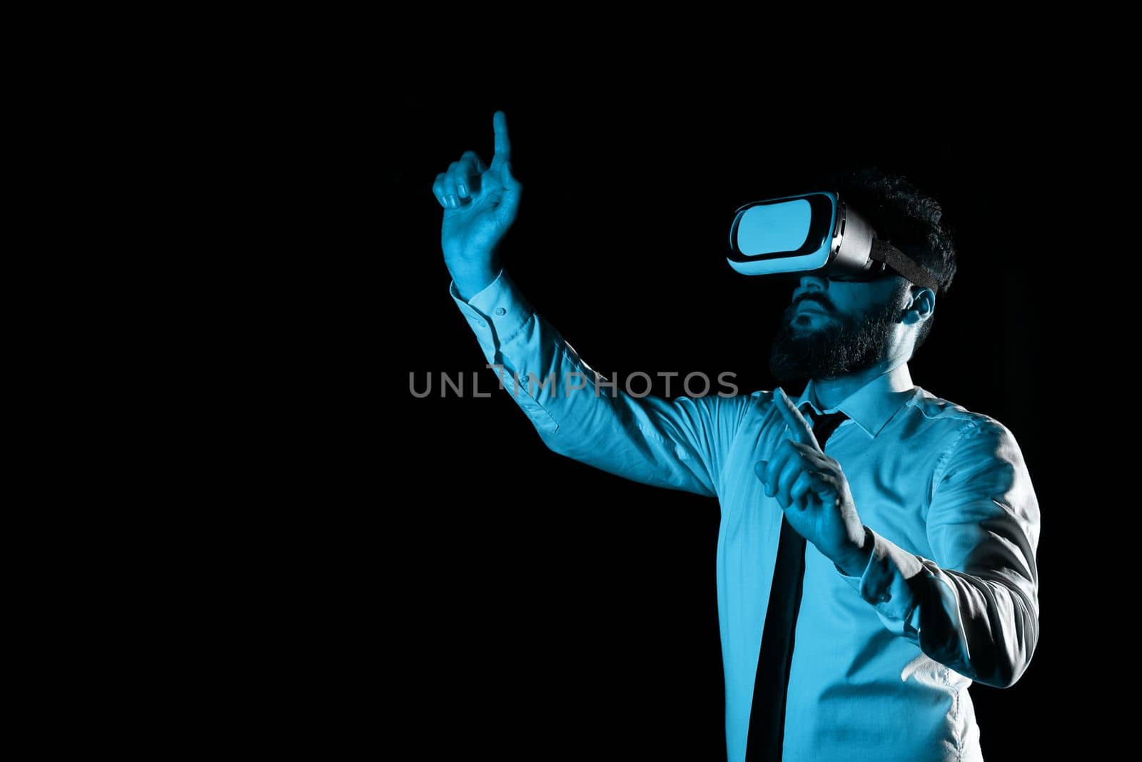 Man Wearing Vr Glasses And Pointing On Important Messages With two Fingers. Businessman Having Virtual Reality Eyeglasses And Showing Crutial Informations. by nialowwa