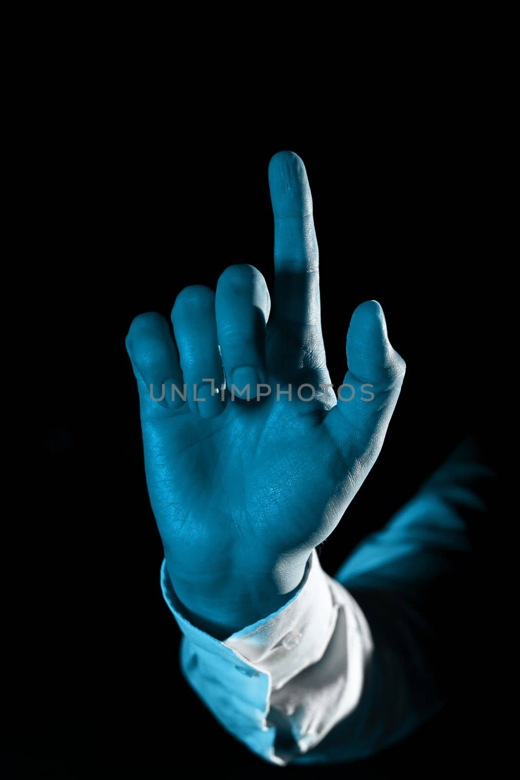 Man hand Pointing On Important Messages With one Finger. Businessman Having Virtual Reality Eyeglasses And Showing Crutial Informations. by nialowwa