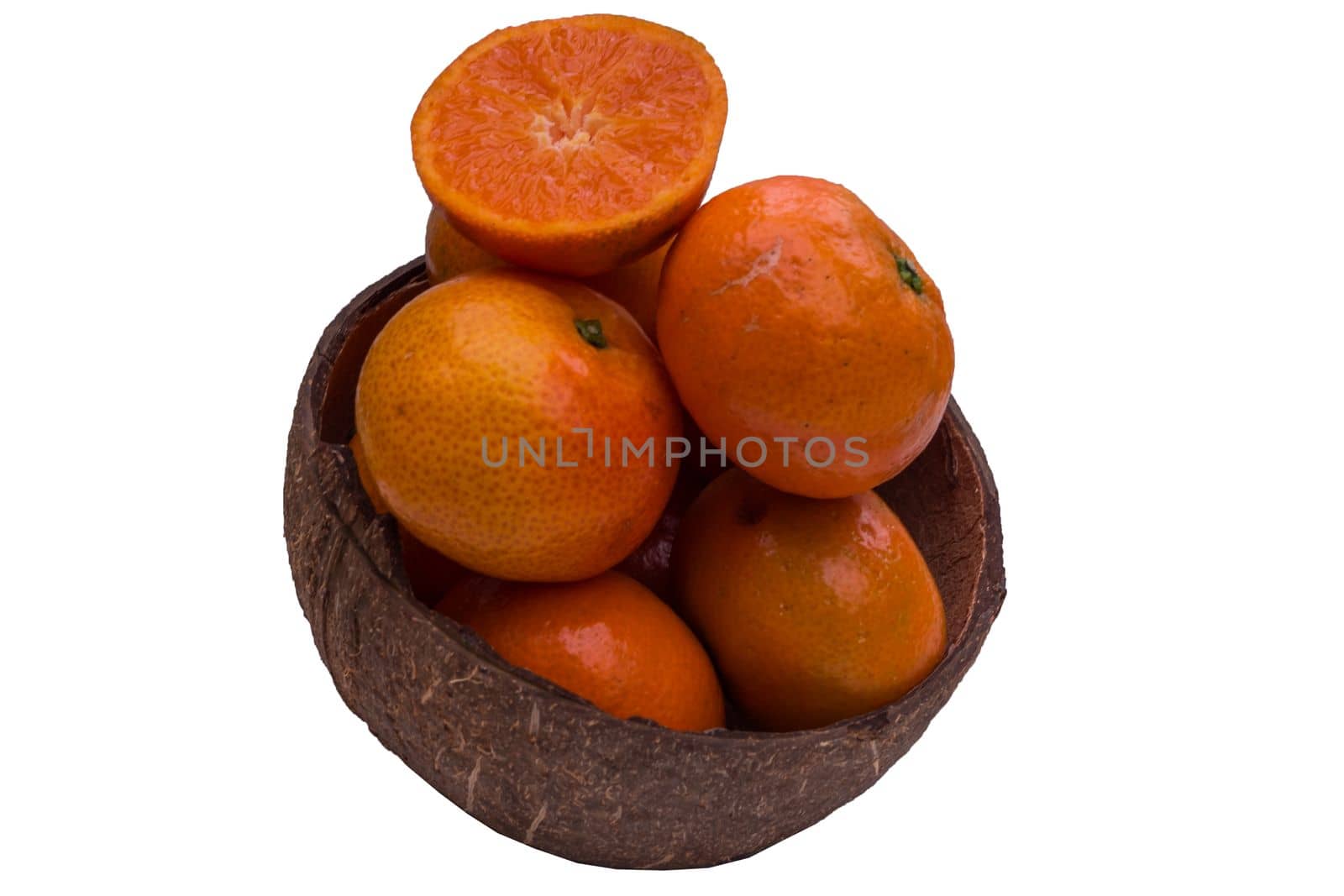 Fresh orange in a coconut shell on a white background.