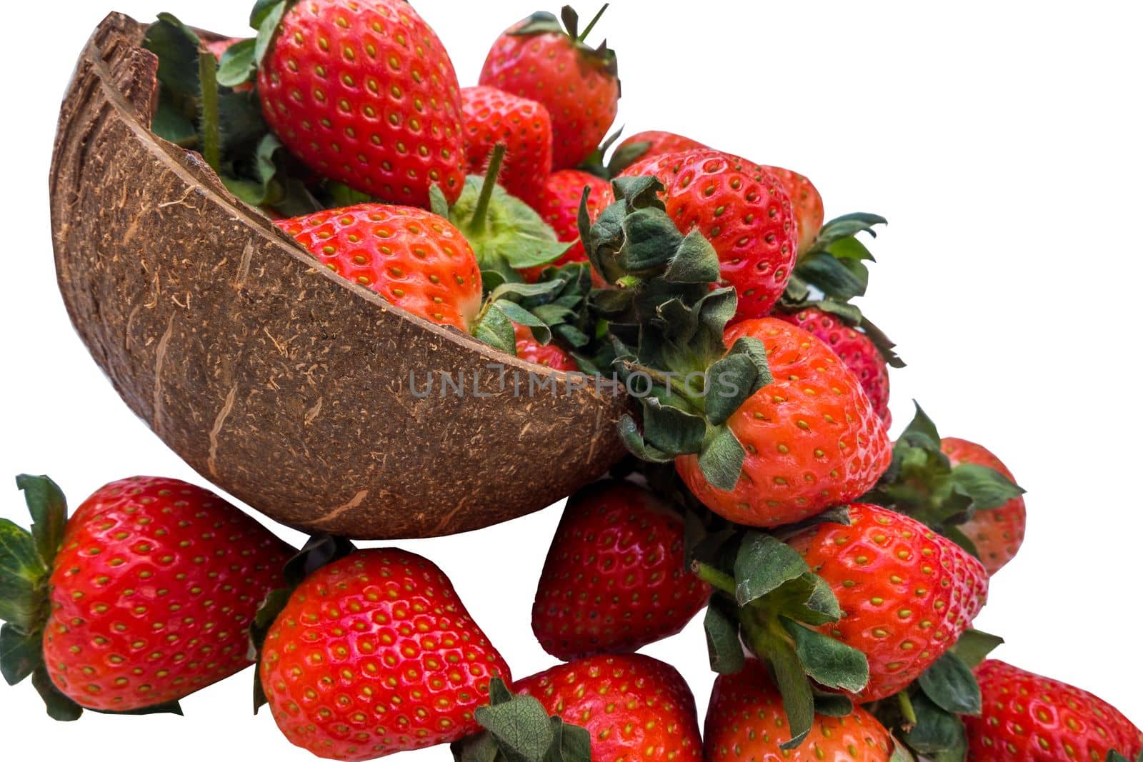 Fresh strawberries in a coconut shell on white background.