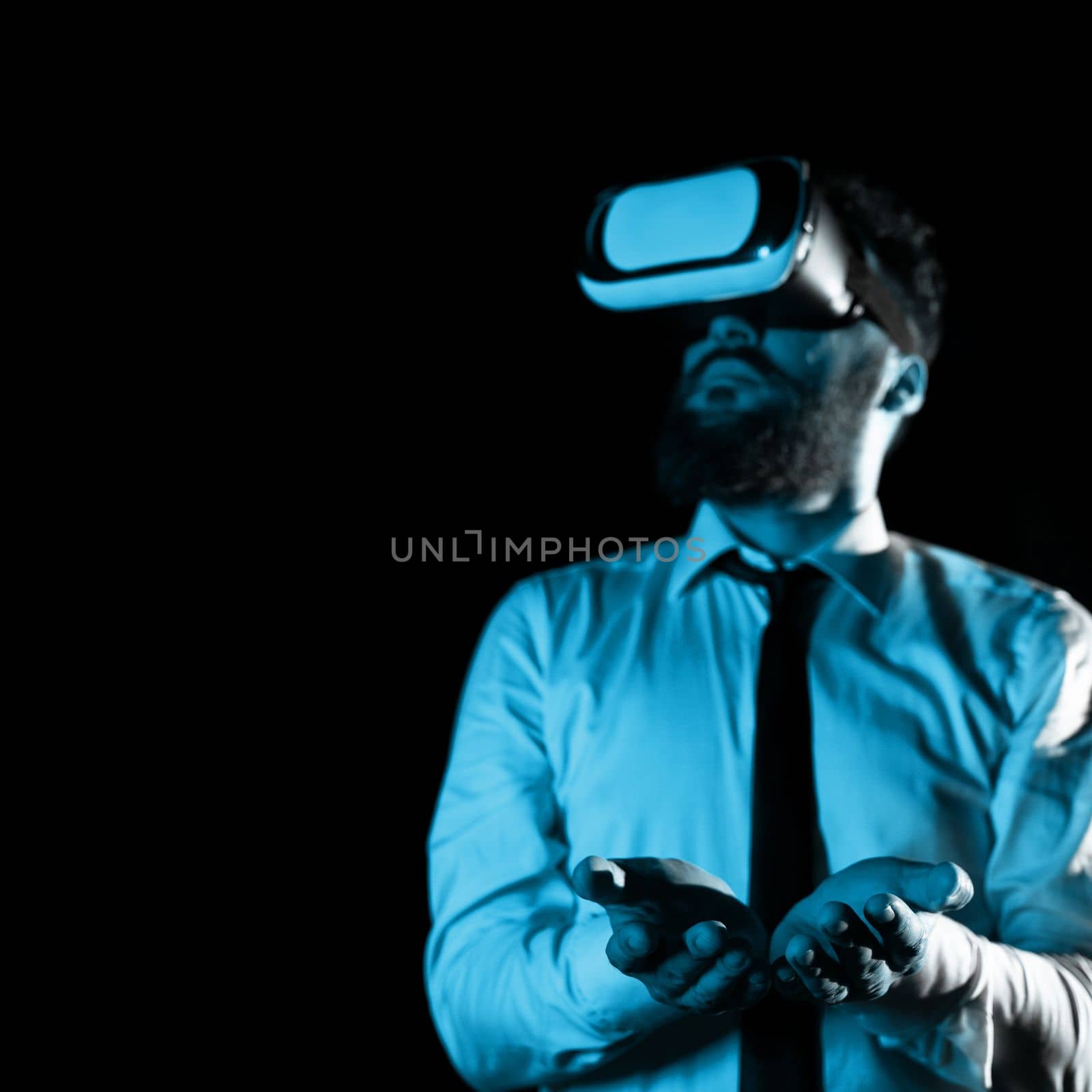 Man Wearing Vr Glasses And Holding Important Messages In Hands. Businessman Having Virtual Reality Eyeglasses And Showing Crutial Informations. by nialowwa
