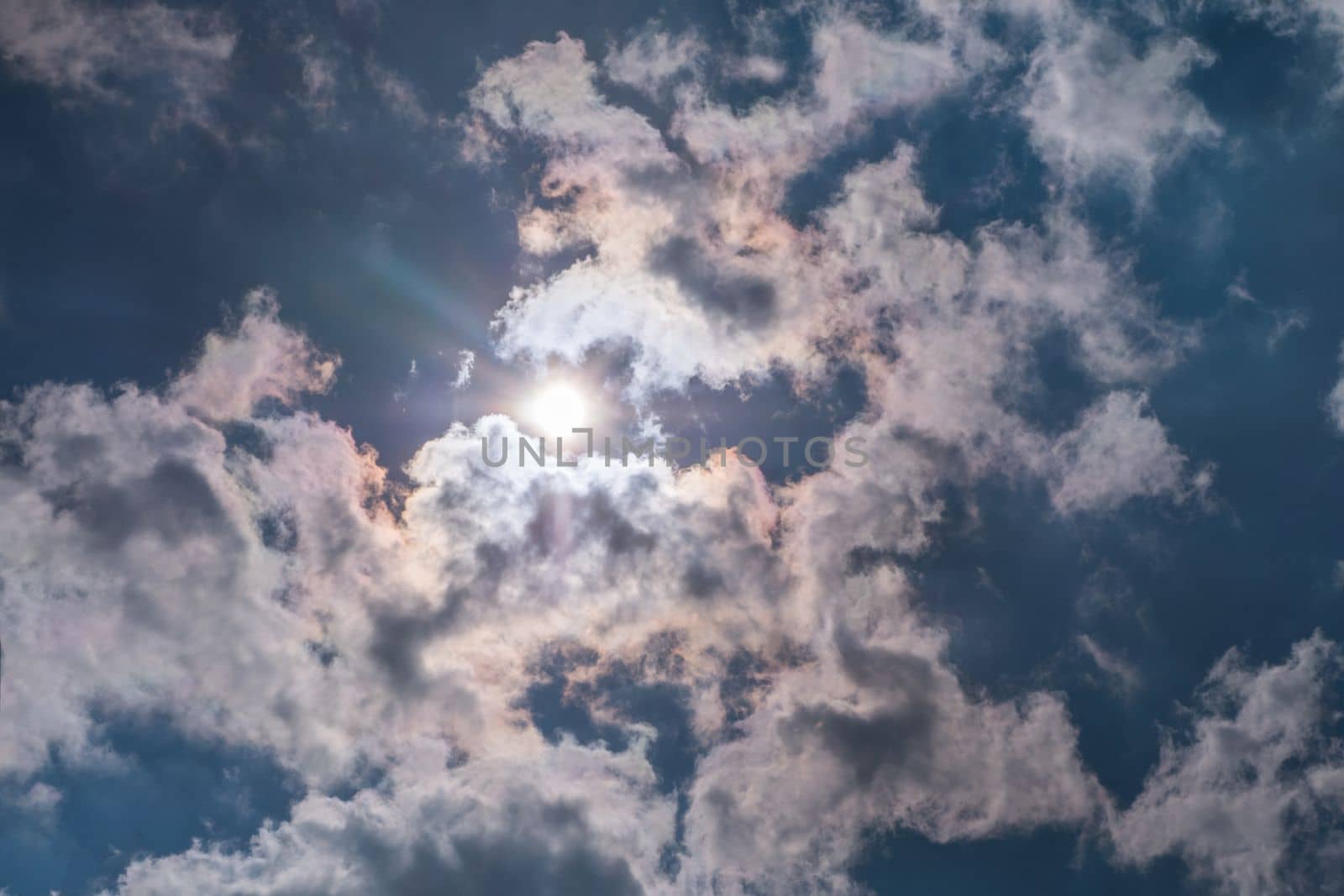 Sunbeam through the haze on blue sky , clouds with sun rays Suitable for making background images.