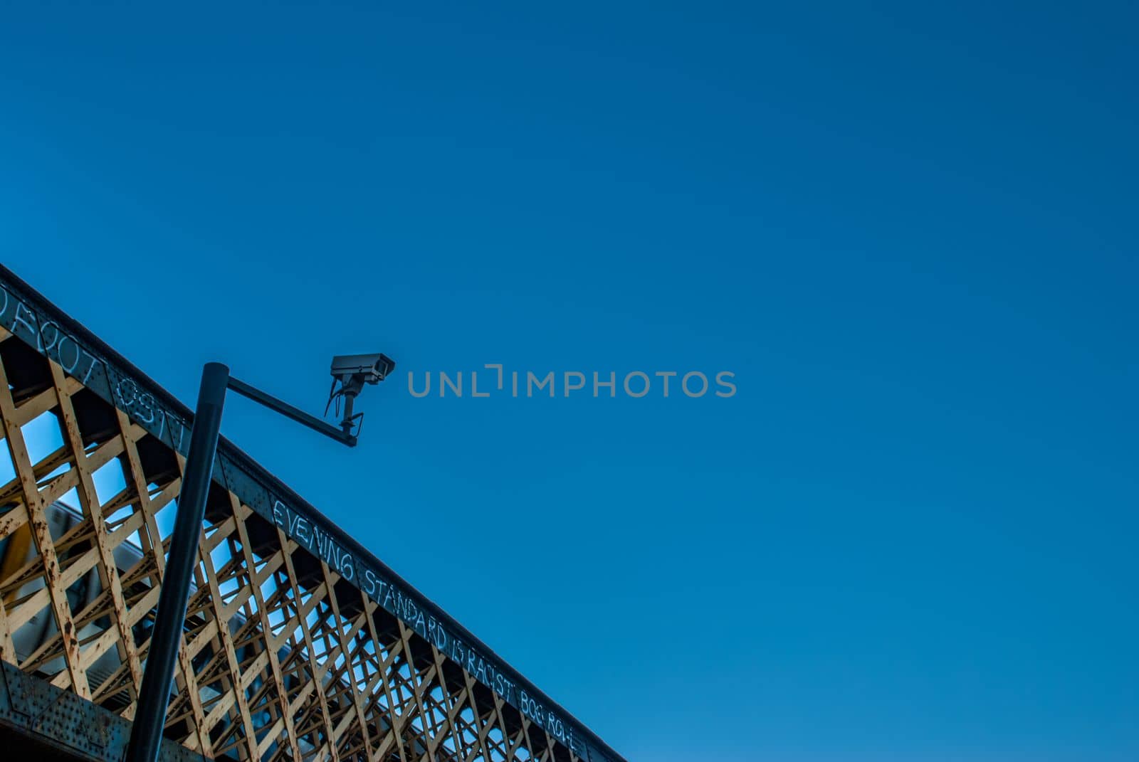 London, UK - Feb 25, 2019 : Modern CCTV on the wall, background, bridge and sky The concept of surveillance and visual inspection that has been developed