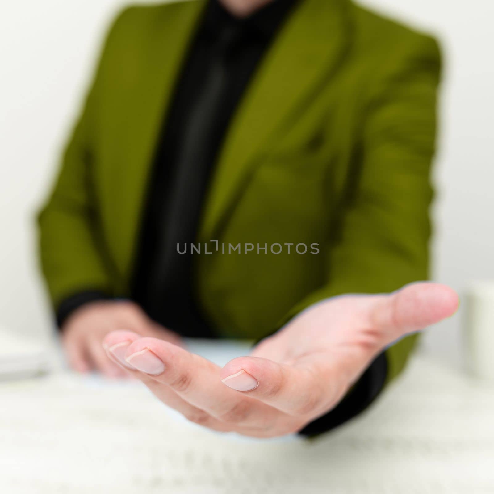 Businessman in Green jacket Holding Important Message In One Hand. Man In Suit Showing New Crutial Idea In Palm. Executive Presenting Updated Critical Information. by nialowwa