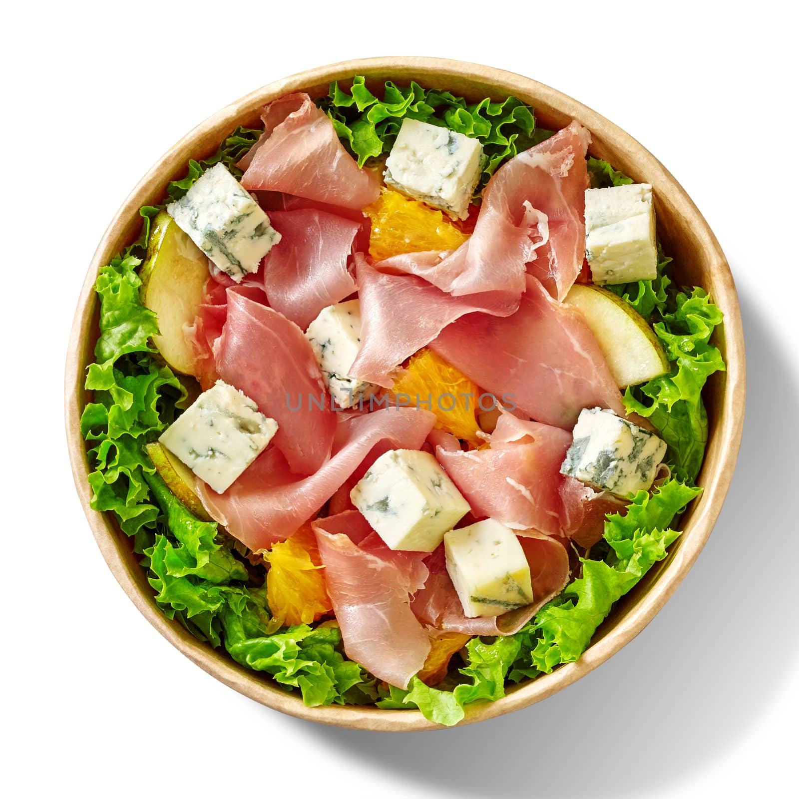 Fresh salad with fresh lettuce, thin slices of cured Italian prosciutto, noble blue cheese, sweet orange and pear seasoned with mustard dressing served in cardboard bowl, top view isolated on white