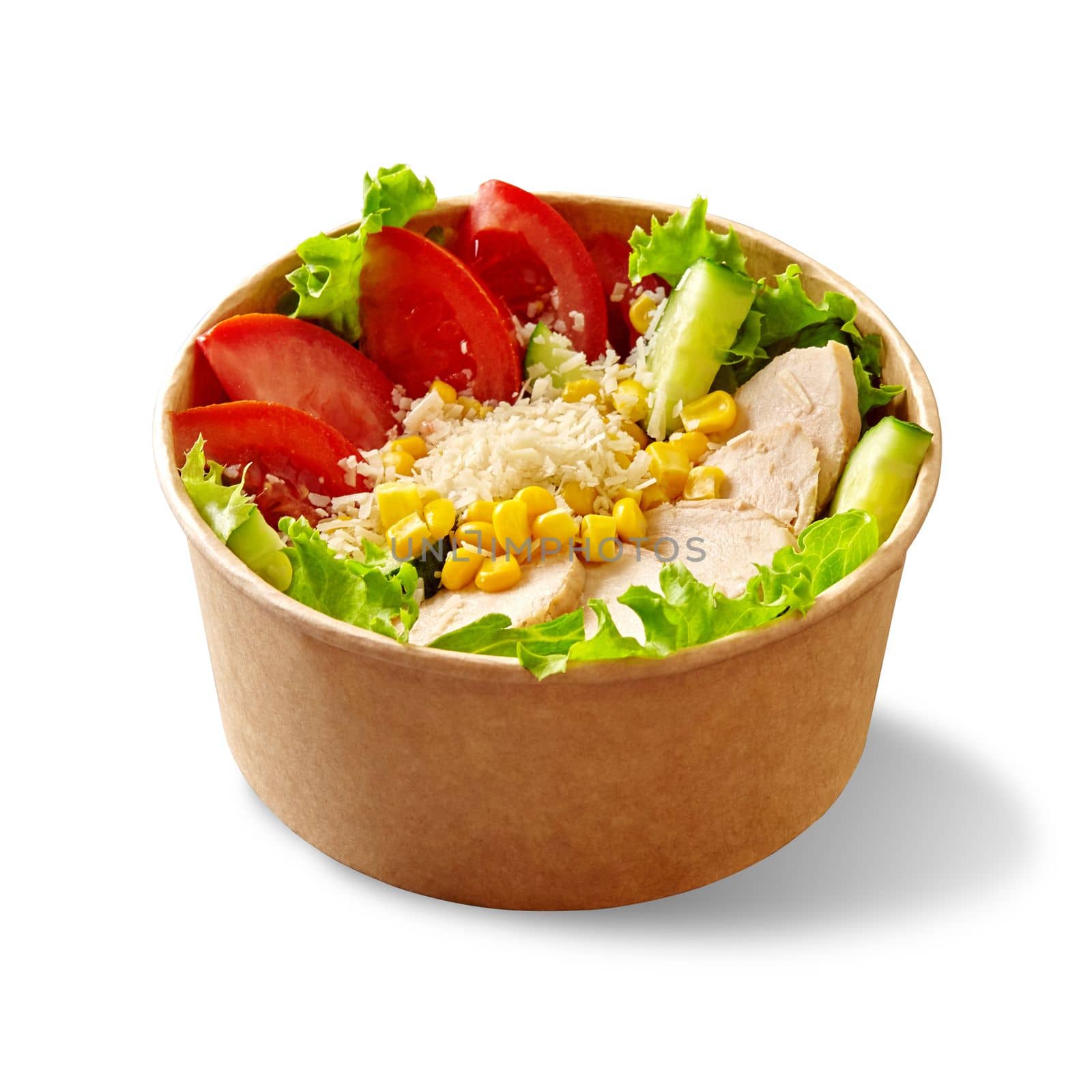 Salad of fresh lettuce leaves, chopped ripe tomato and cucumber with chicken fillet, corn kernels and grated parmesan in cardboard cup isolated on white background. Healthy snack. Delivery food