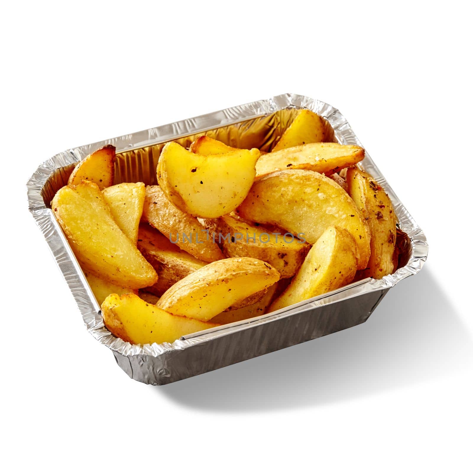 Golden baked potato wedges in aluminium foil container isolated on white background by nazarovsergey