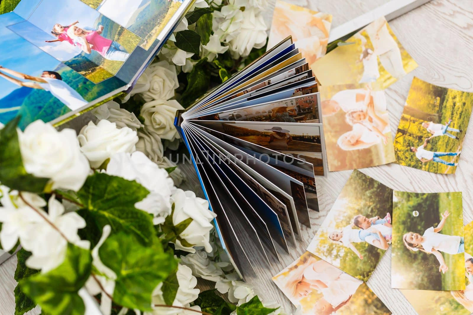 printed photos of family summer vacation lying on desk