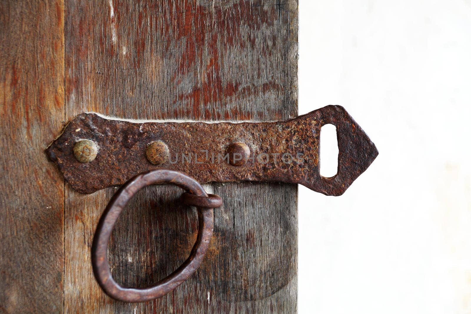 ancient metal lock on an old wooden door close-up