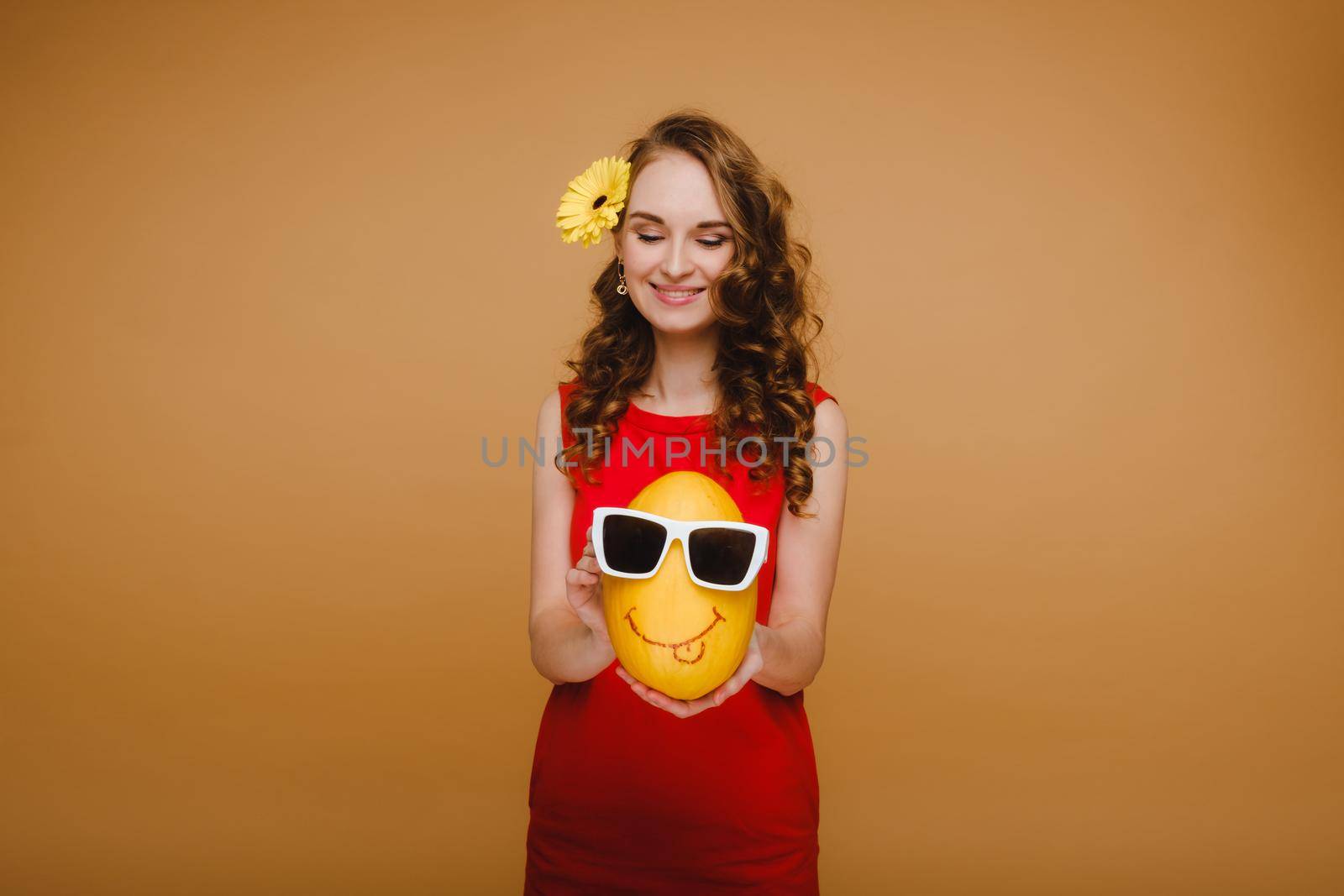 Portrait of a happy young woman holding a melon with glasses. Melon with a smile.