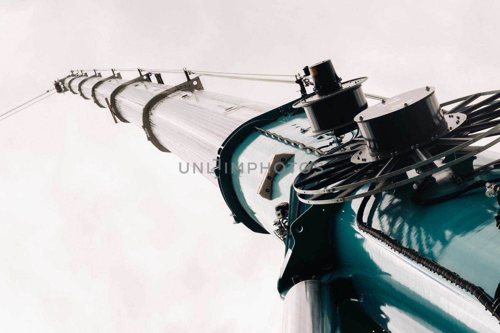 blue crane lifting mechanism with hooks near the glass modern building, crane and hydraulic high lift up to 120 meters by Lobachad