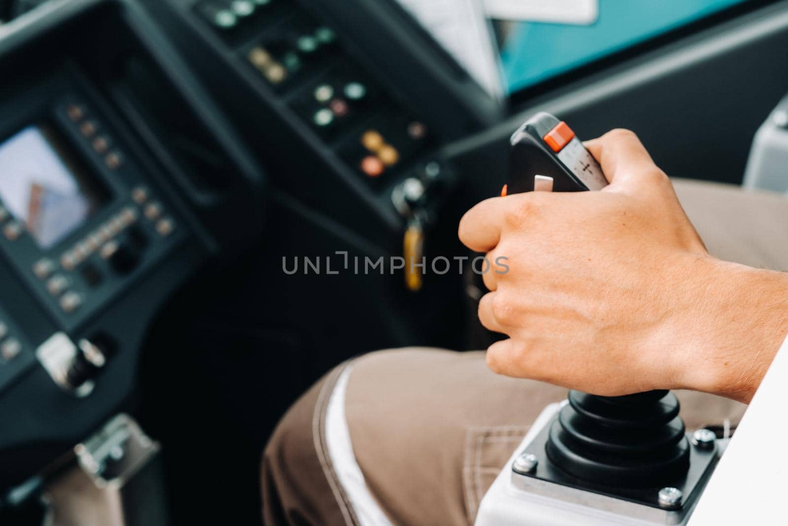 Close up of a hand holding the control stick and ready to work in the truck crane the largest truck crane for challenging tasks.