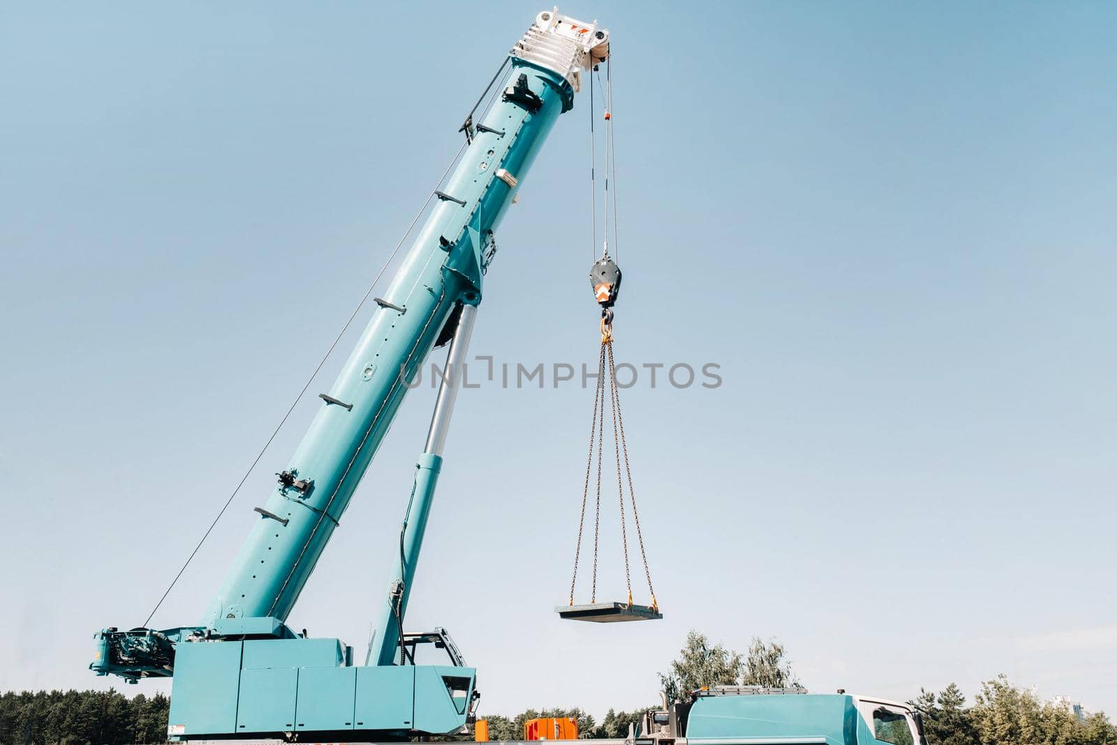 the stove is loaded onto a large blue car crane and prepared for operation . The largest truck crane for solving complex tasks. by Lobachad