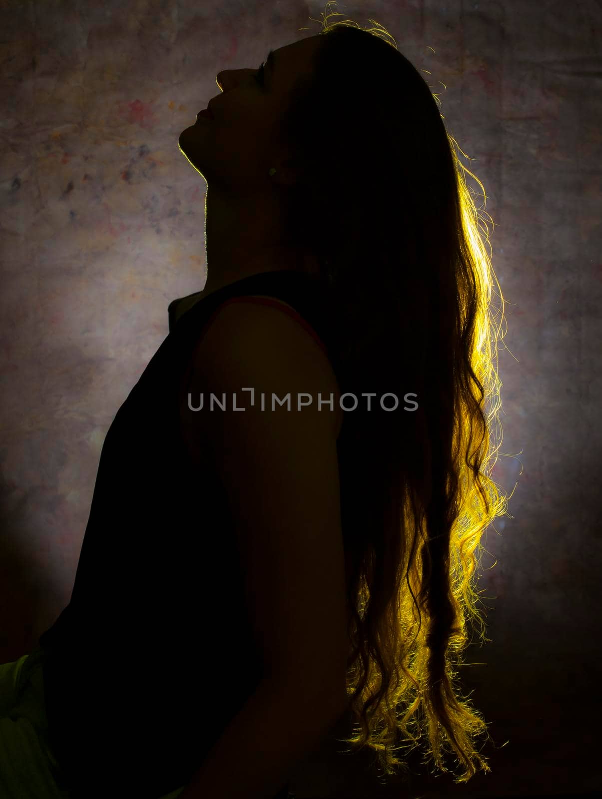 Portrait against the light of a young woman by bepsimage