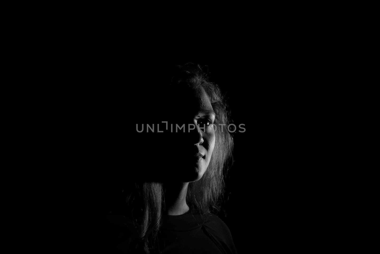 Black and white portrait of an Italian young woman on black background