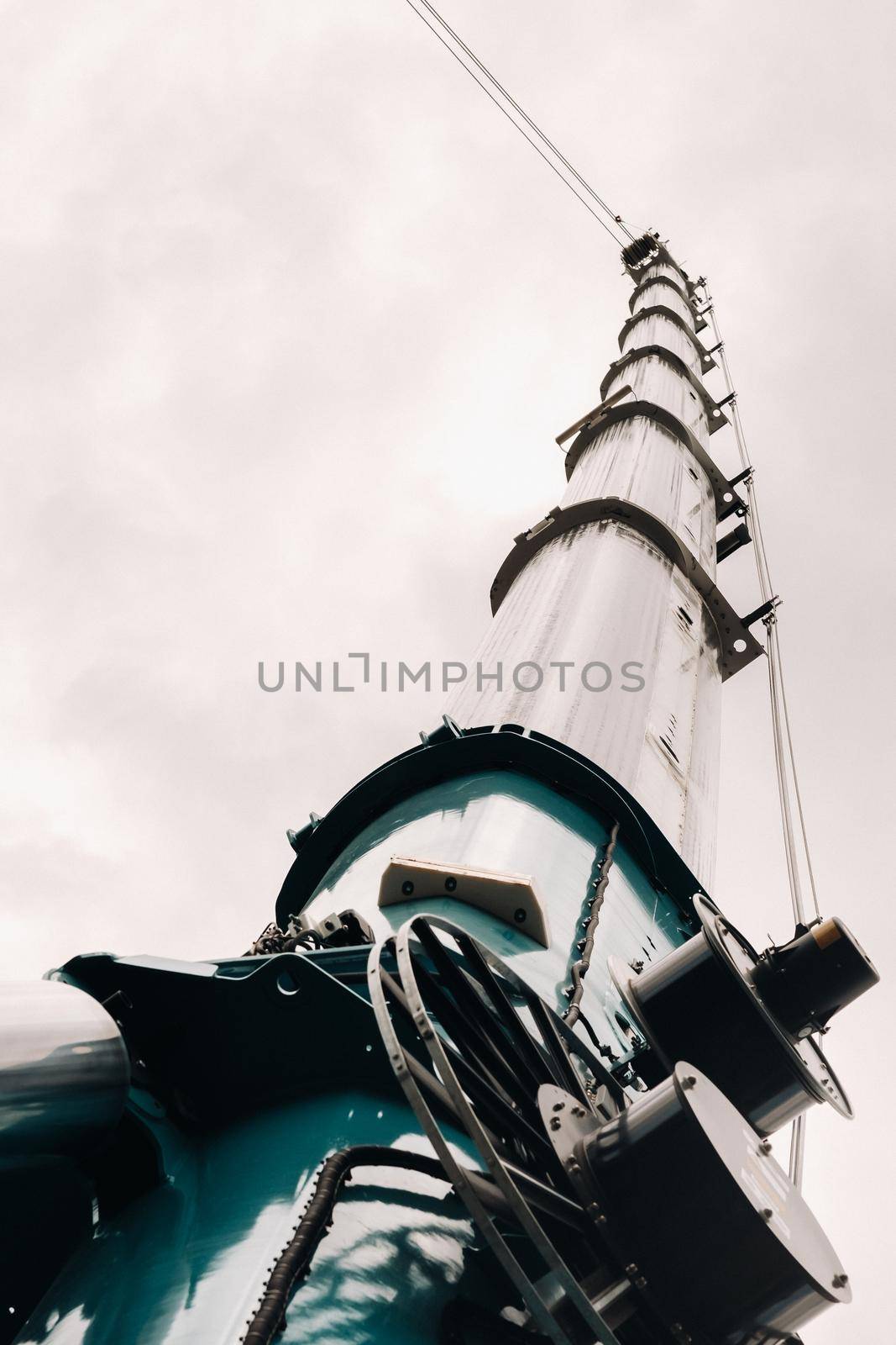 blue crane lifting mechanism with hooks near the glass modern building, crane and hydraulic high lift up to 120 meters by Lobachad