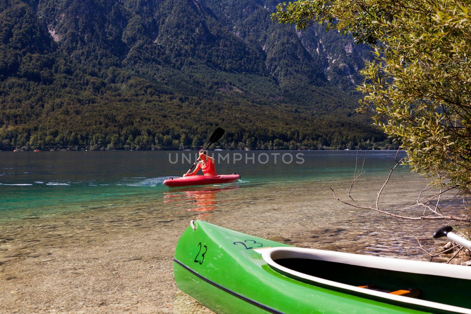 Girl kayaking in the Bohinj lake by bepsimage