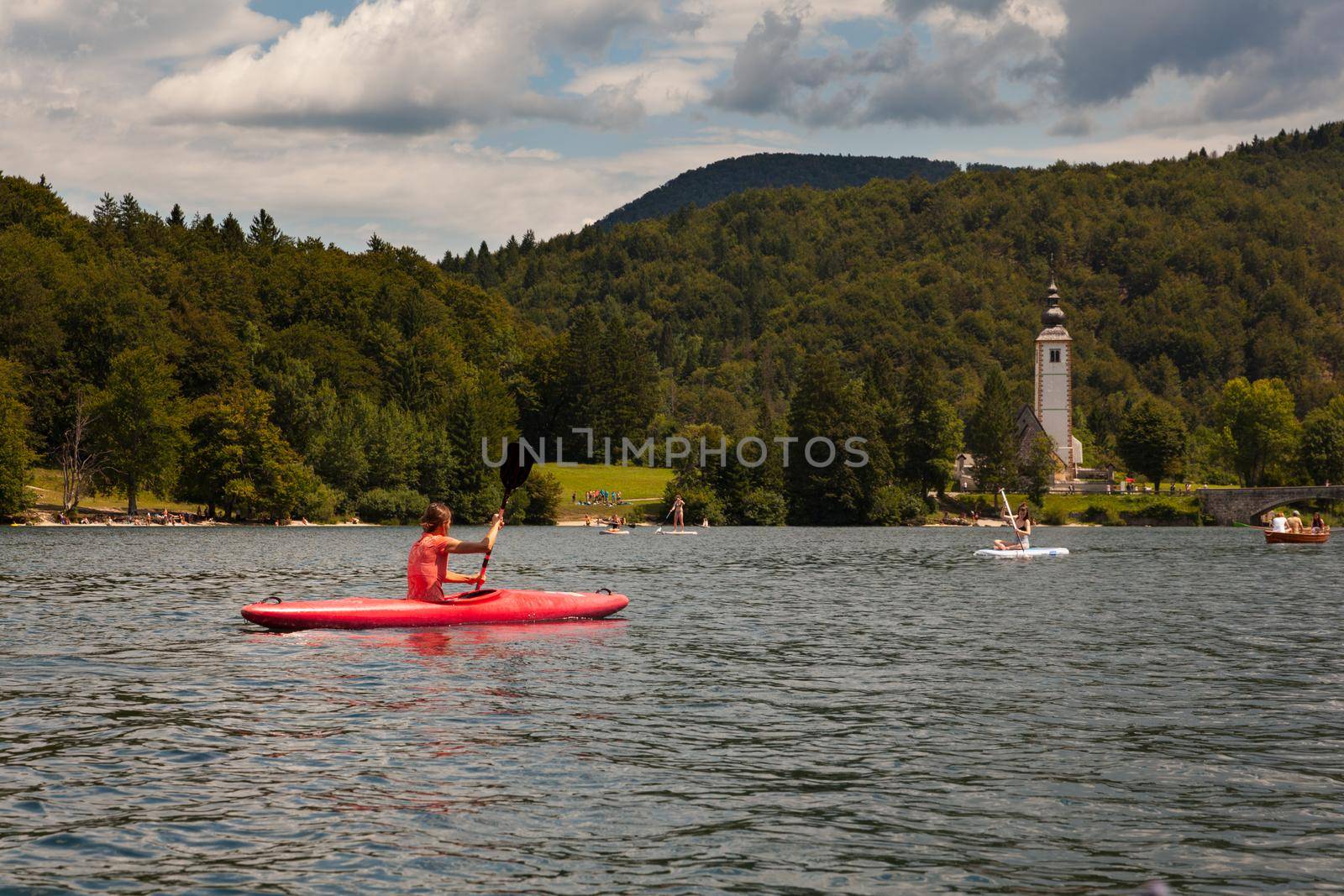 Girl kayaking in the Bohinj lake by bepsimage