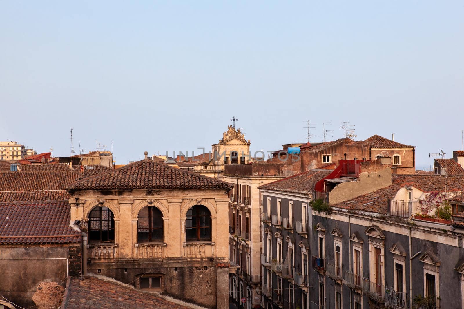 Top view of Catania baroque buildings from the Badia church at sunset