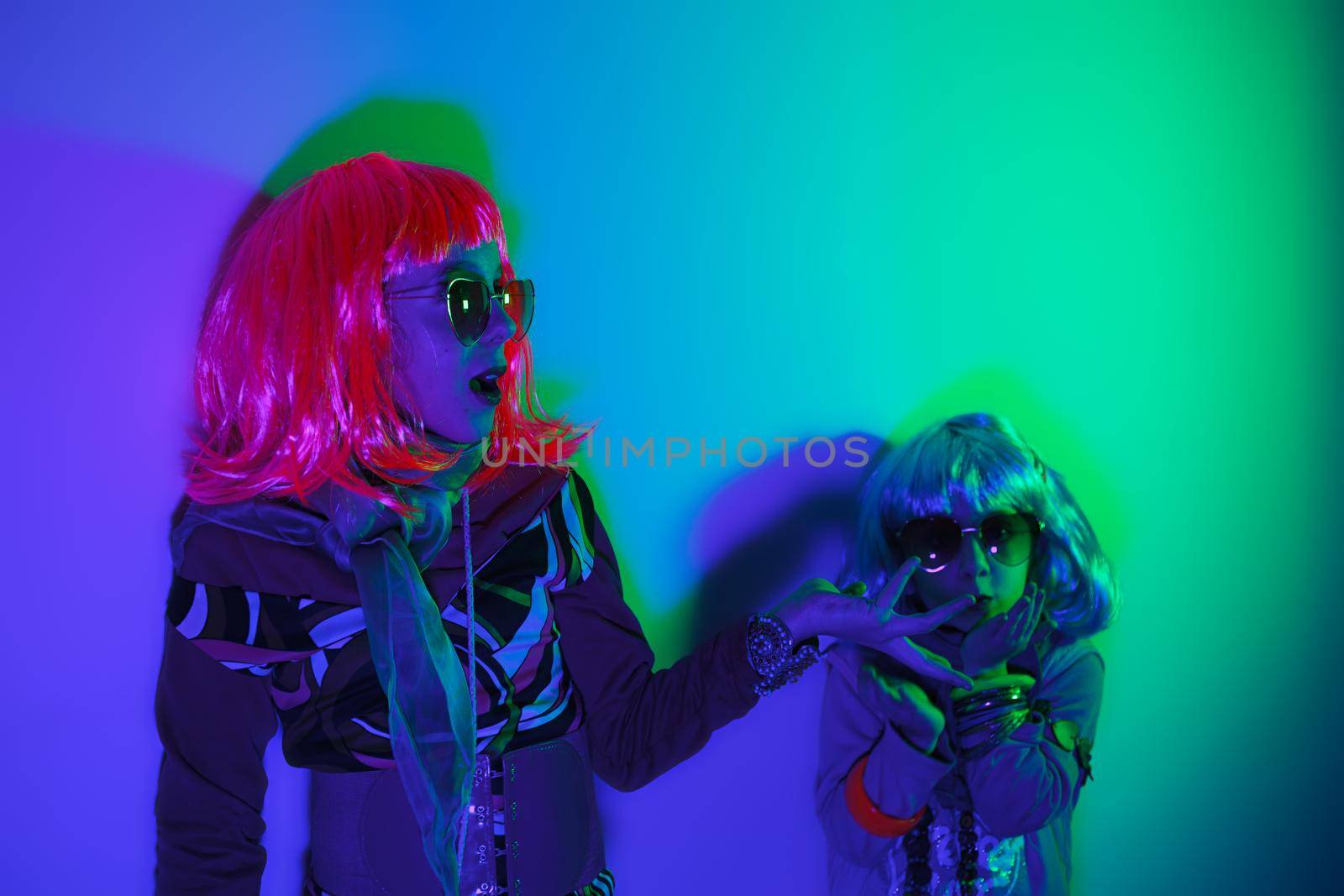 Two little girls wearing a colorful wig and heart-shaped sunglasses posed for a photo shooting by bepsimage