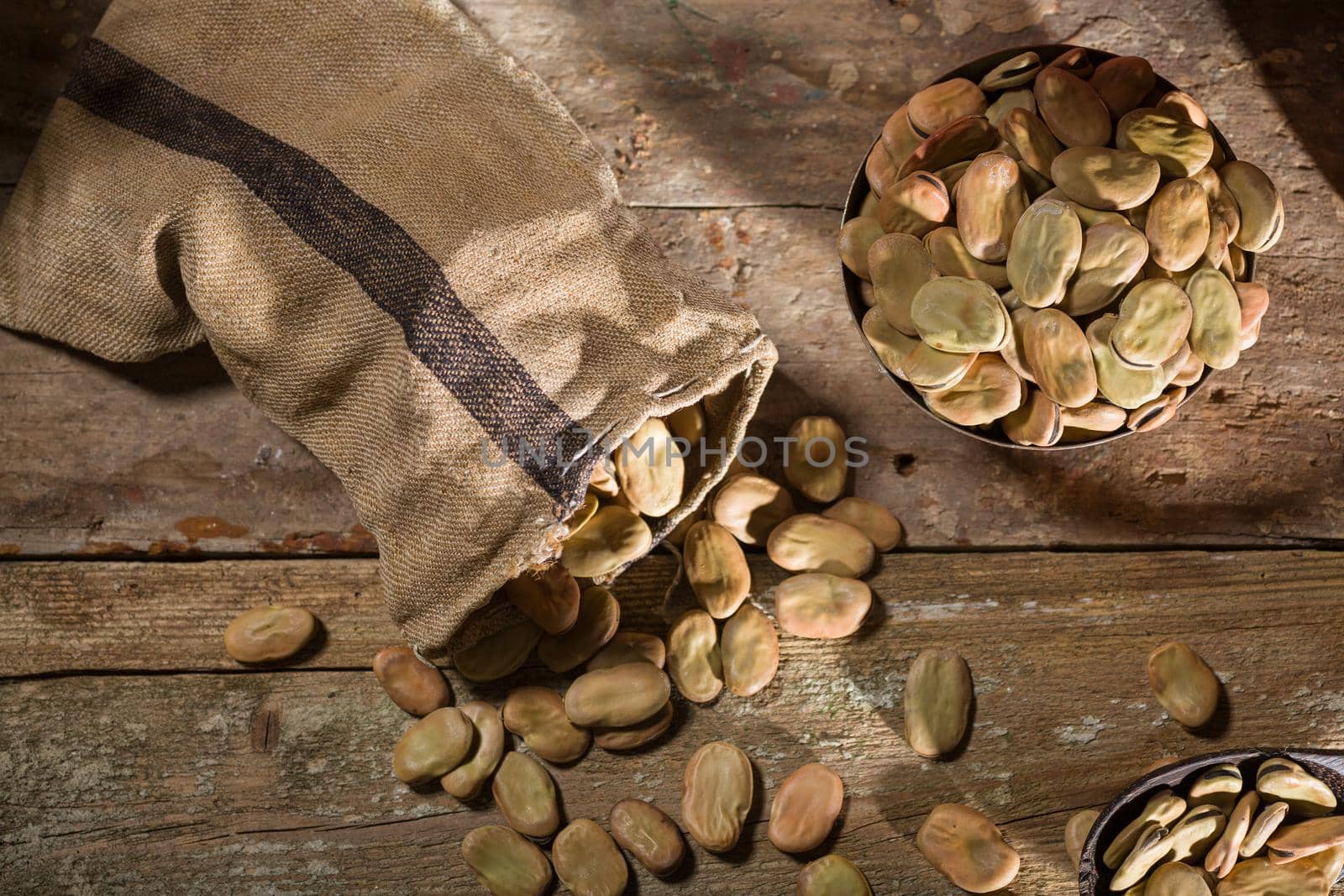 Top view of dried broad beans on wooden table
