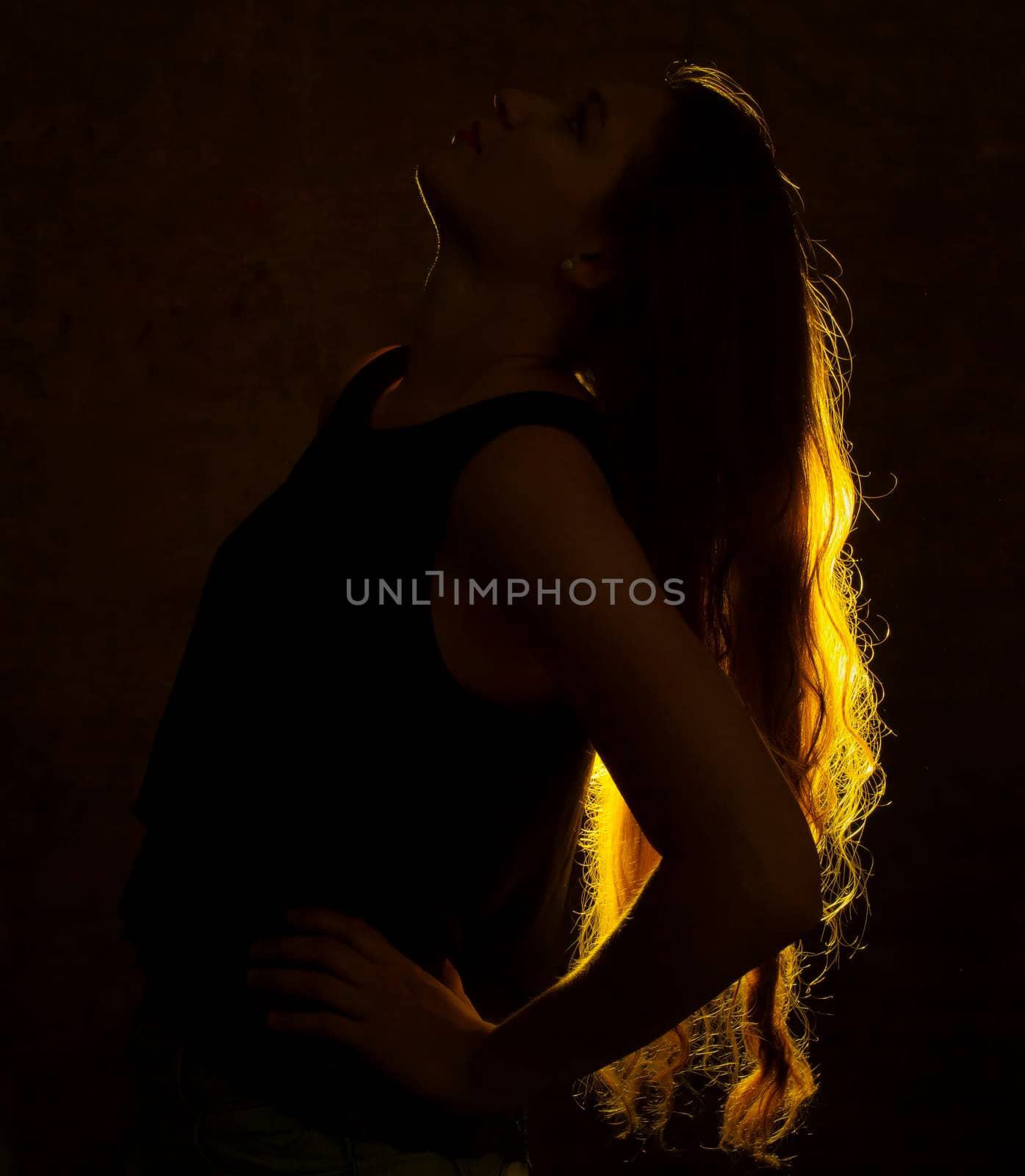 Portrait against the light of a young woman by bepsimage