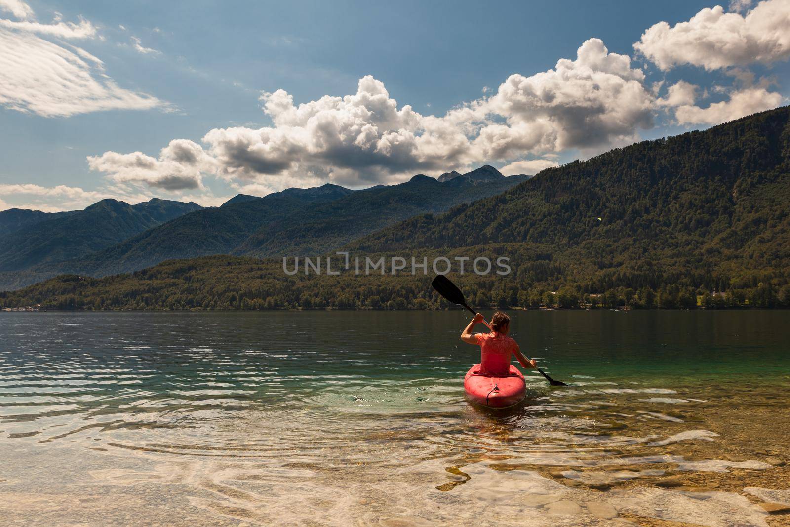 Girl kayaking in the Bohinj lake by bepsimage