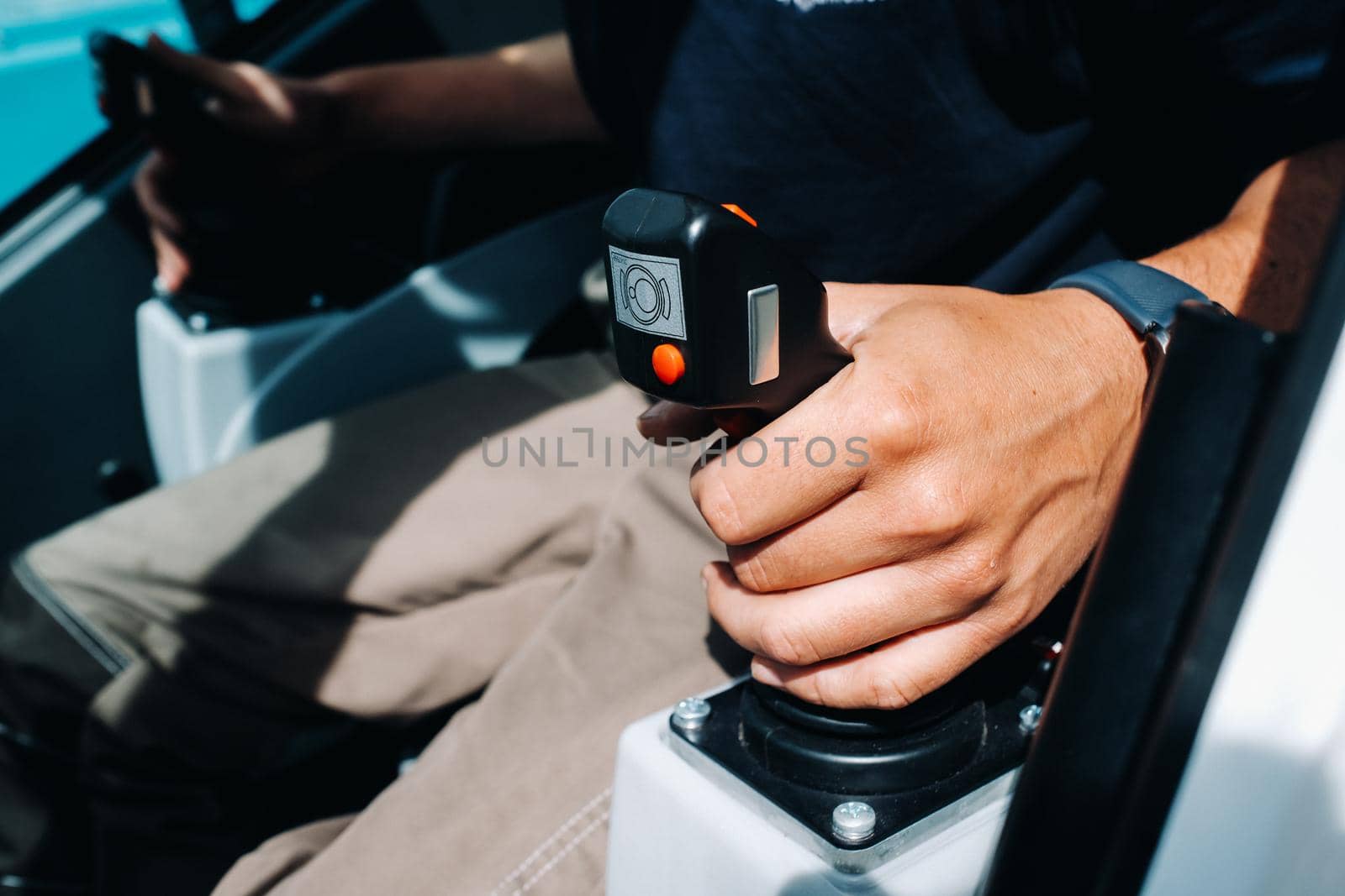 Close up of a hand holding the control stick and ready to work in the truck crane the largest truck crane for challenging tasks.