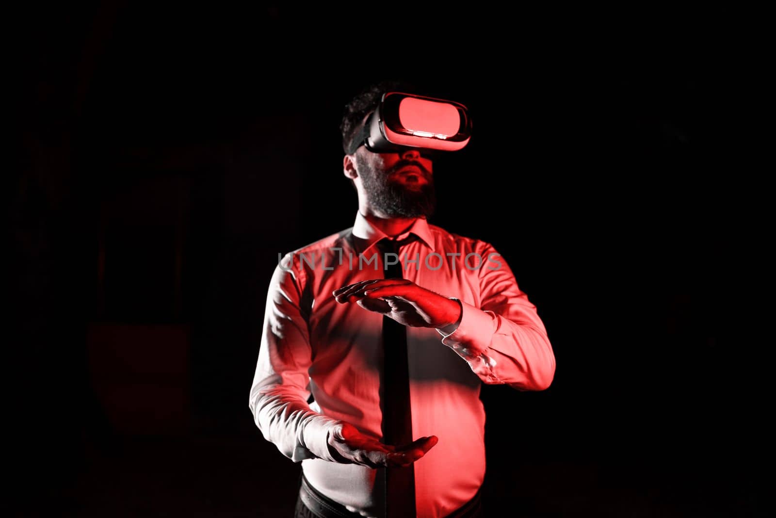 Man Wearing Vr Glasses And Presenting Important Messages Between Hands. Businessman Having Virtual Reality Eyeglasses And Showing Crutial Informations. by nialowwa