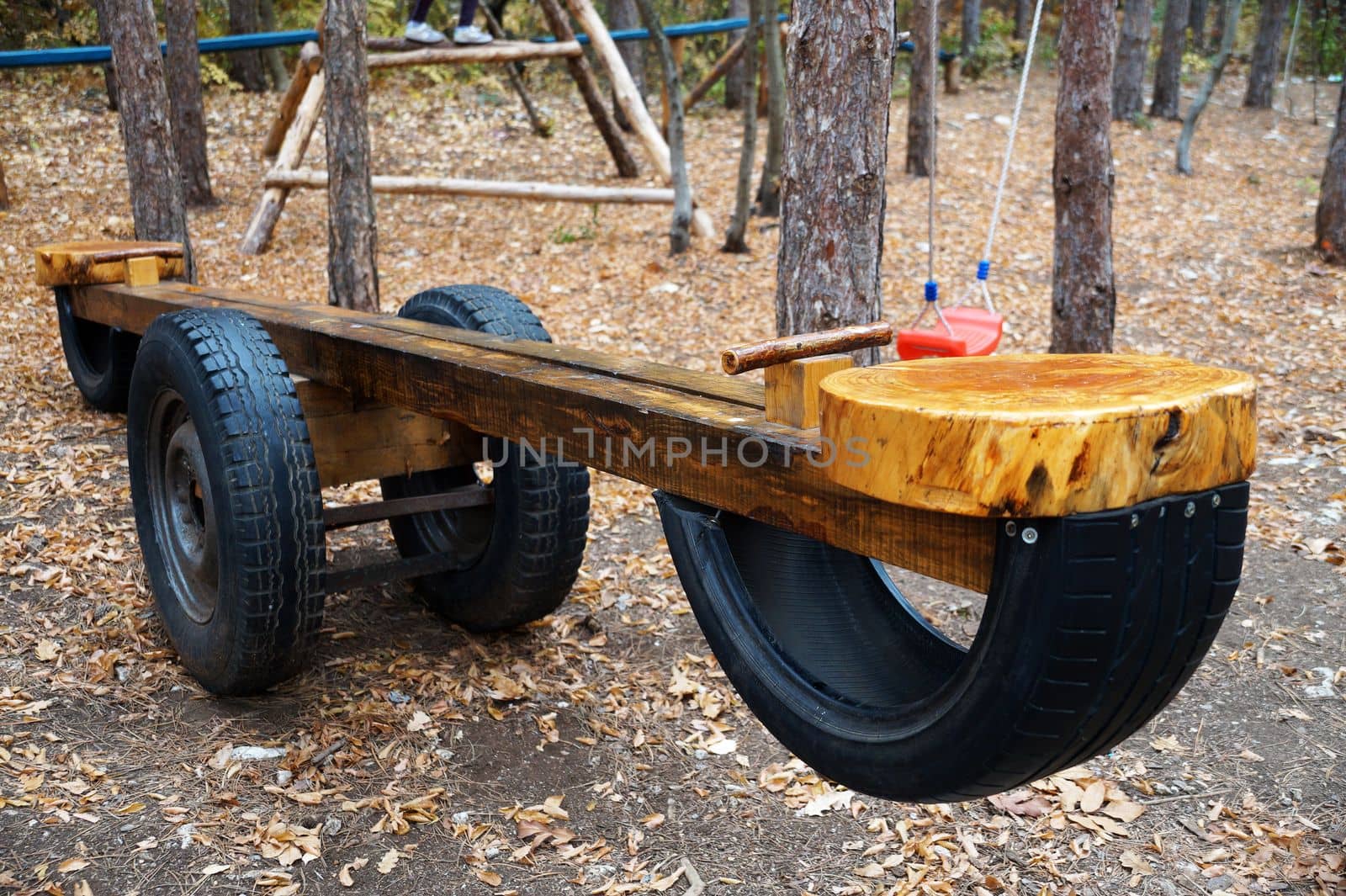 homemade swing from wooden beams and car tires by Annado