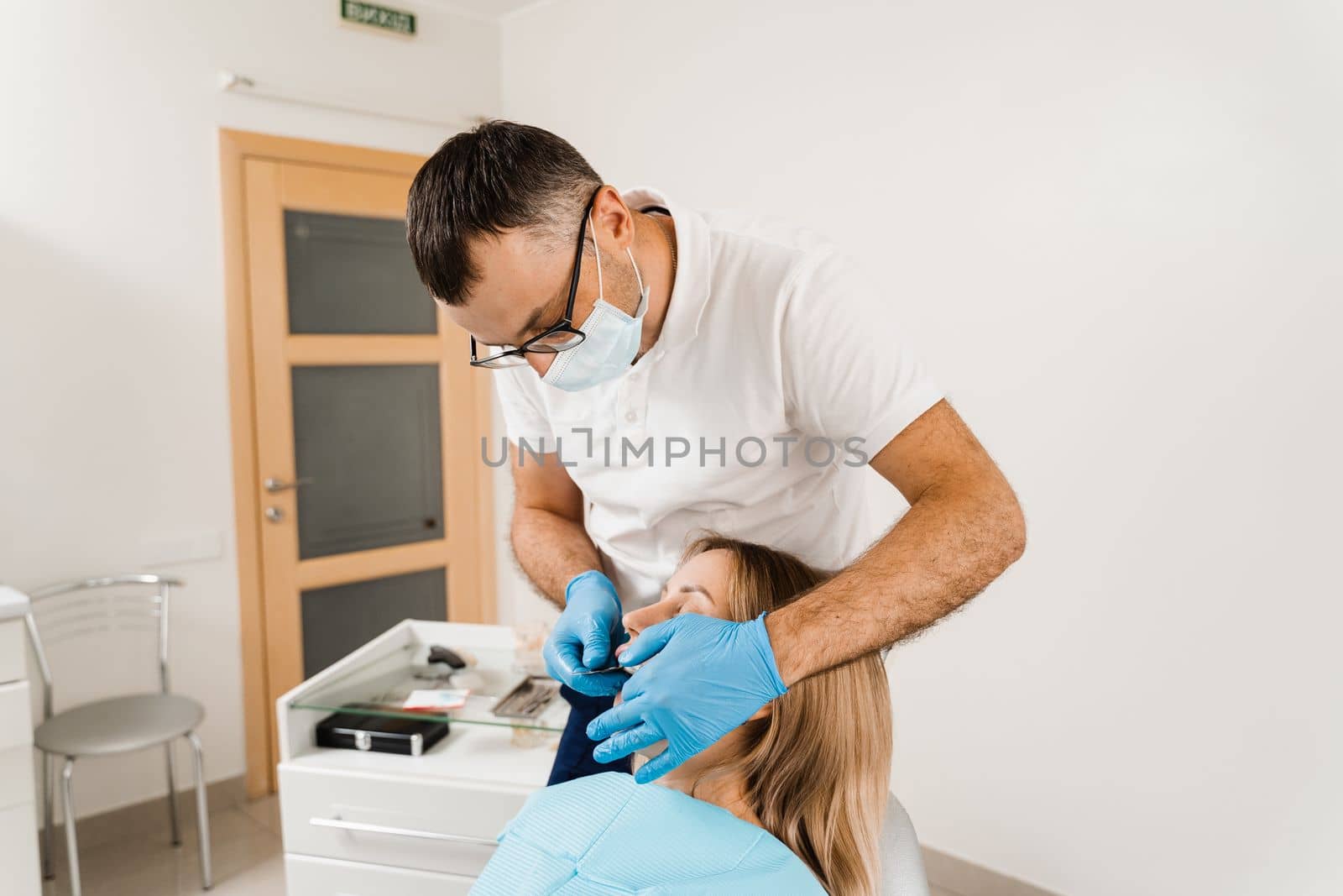Procedure of creating dental prostheses, crowns and aligners. Doctor inserts impression tray and making cast of teeth to patient in dentistry before dental implantation.