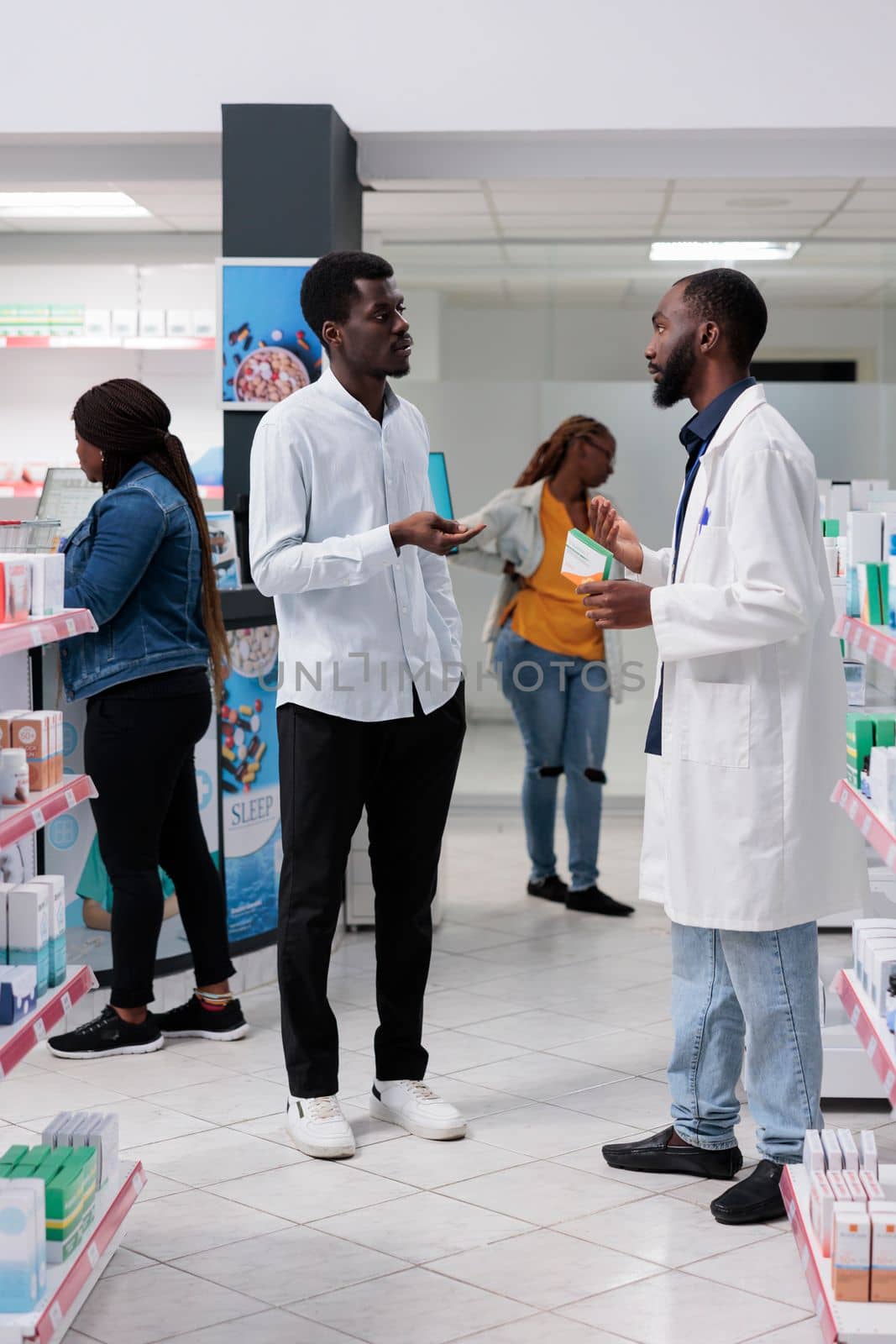 African american customers purchasing medicaments in pharmacy store by DCStudio