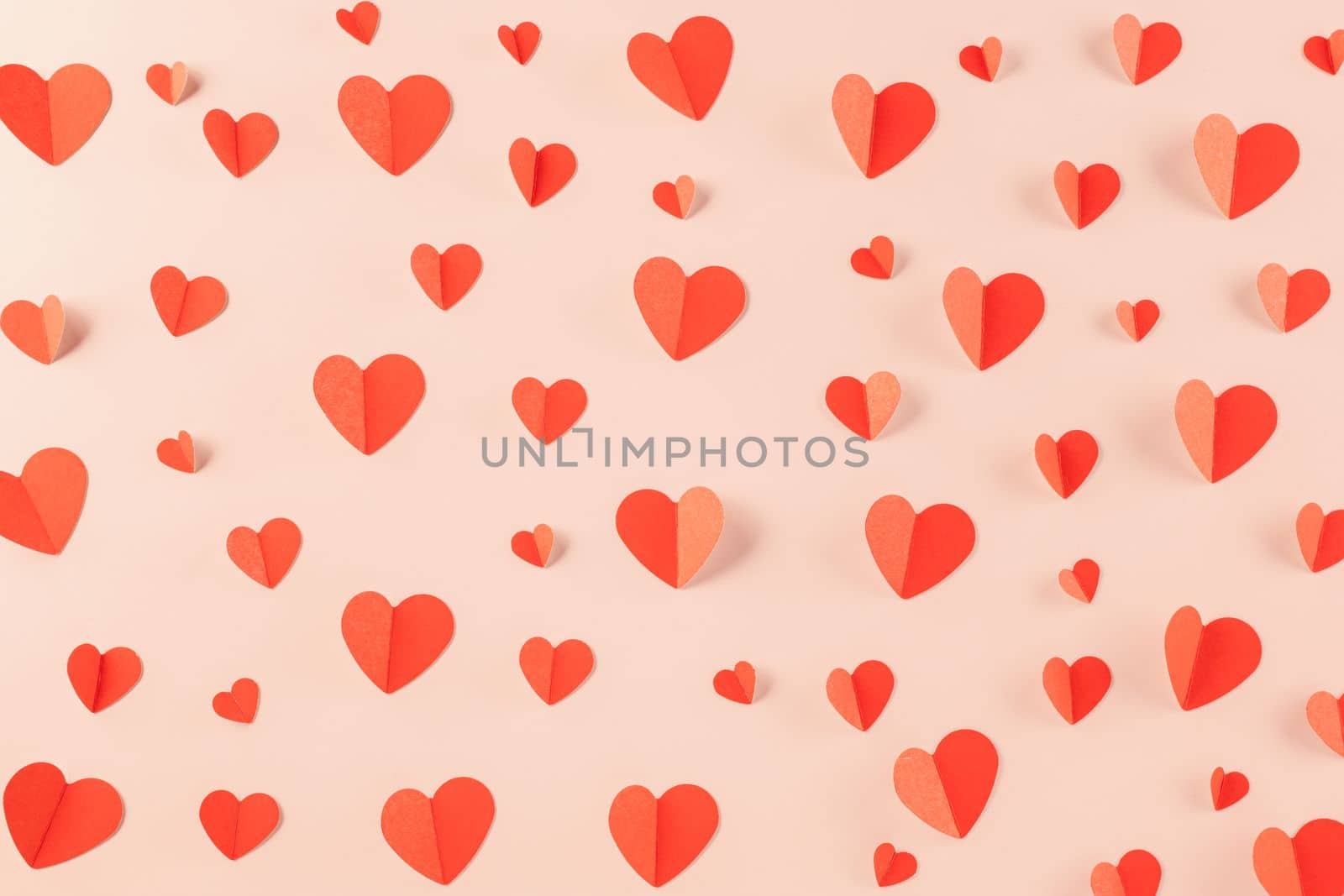 Beautiful red paper hearts shape cutting pastel pink background by Sorapop