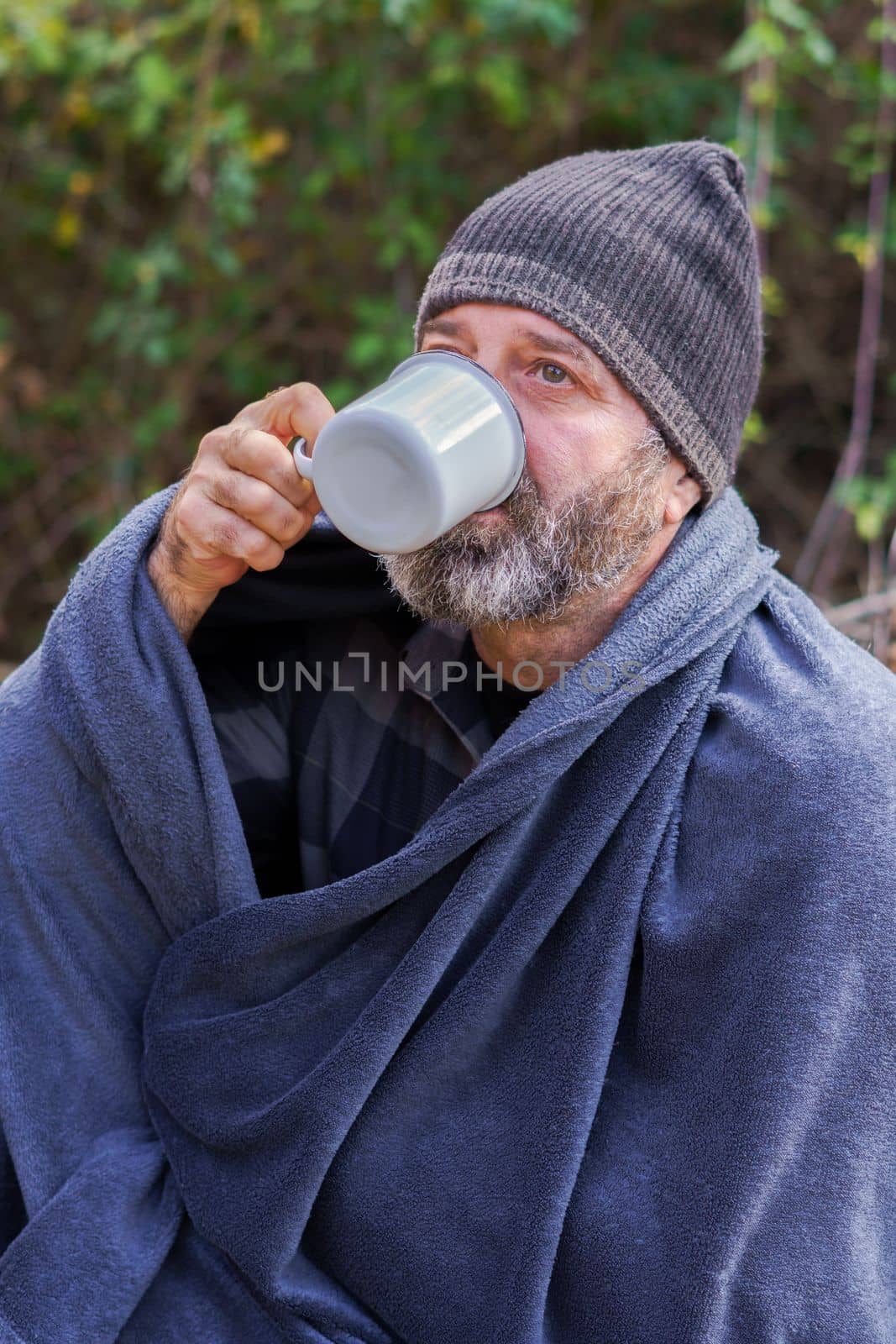 man on a camping trip having a cup of coffee by joseantona