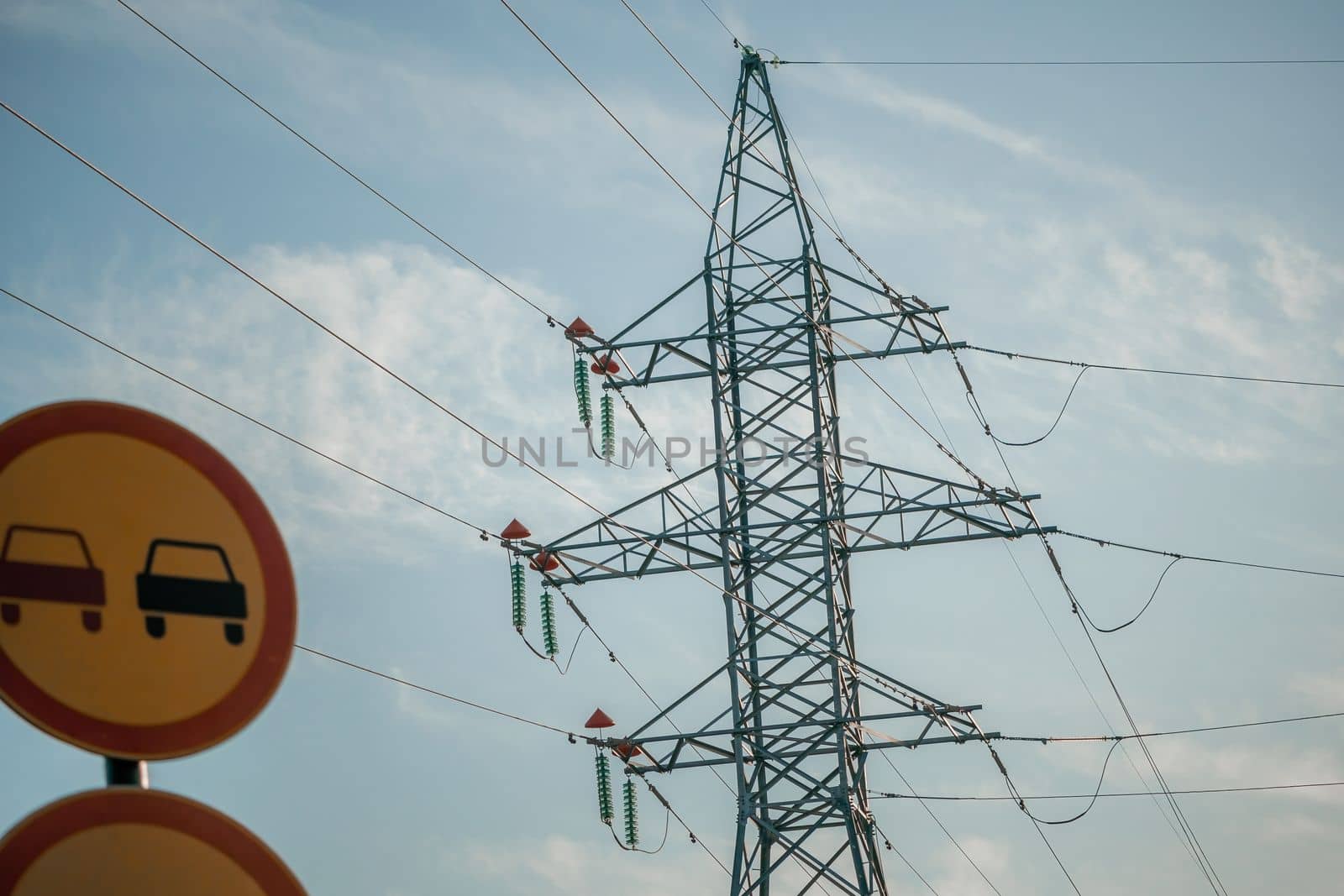 Silhouette High voltage electric tower on sunset time, distribution electric substation with power lines and transformers.