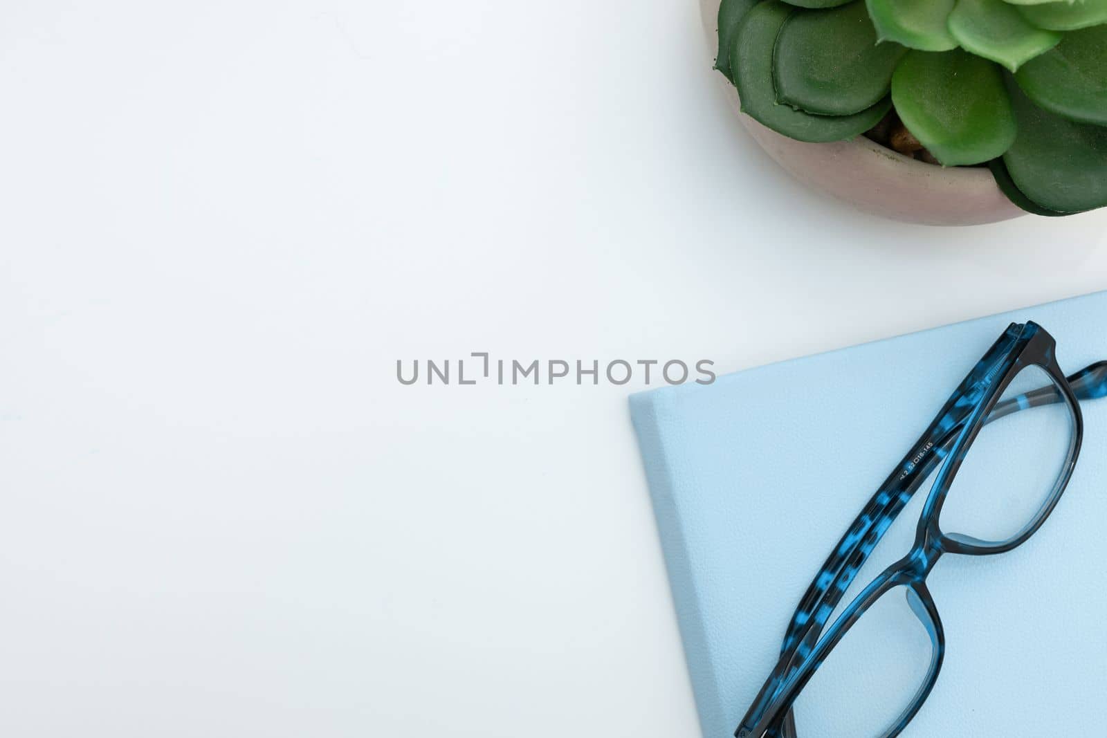 Office Supplies Over Desk With Keyboard And Glasses And Coffee Cup For Working Remotely, Assorted School Utilities For Studying With Hot Drink And Eyeglasses. by nialowwa