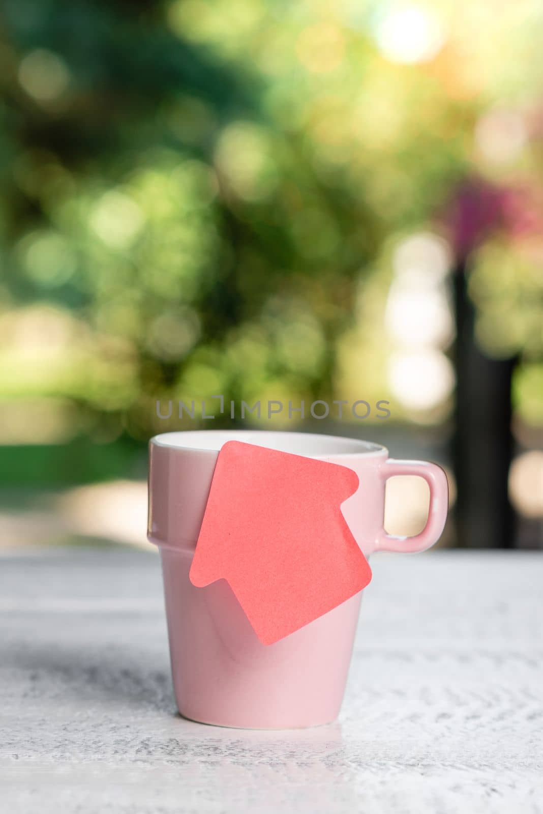 Coffee Cup Standing on Desk. Important infrormation written on paper. Different Office Supplies, Pencils, Pens, Marckers. Computer keyboard. Text on wood table. by nialowwa