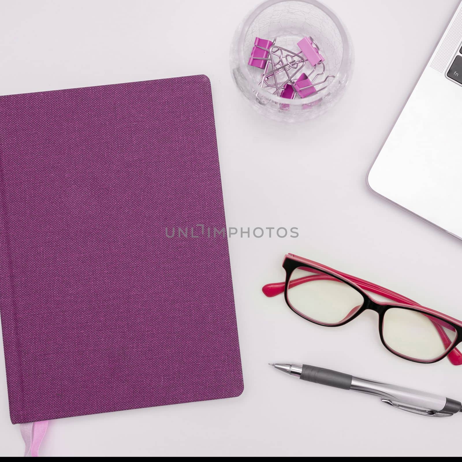Office Supplies Over Desk. Keyboard and Glasses. Assorted School Utilities