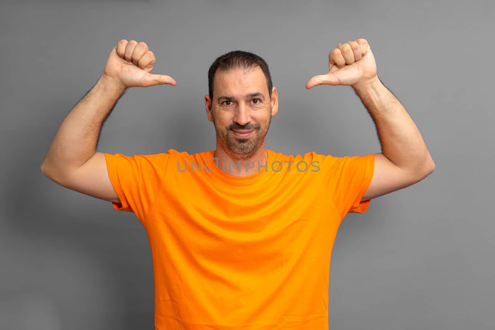 Photo of happy latino man with beard charming good mood smile pointing finger to himself isolated over gray color background