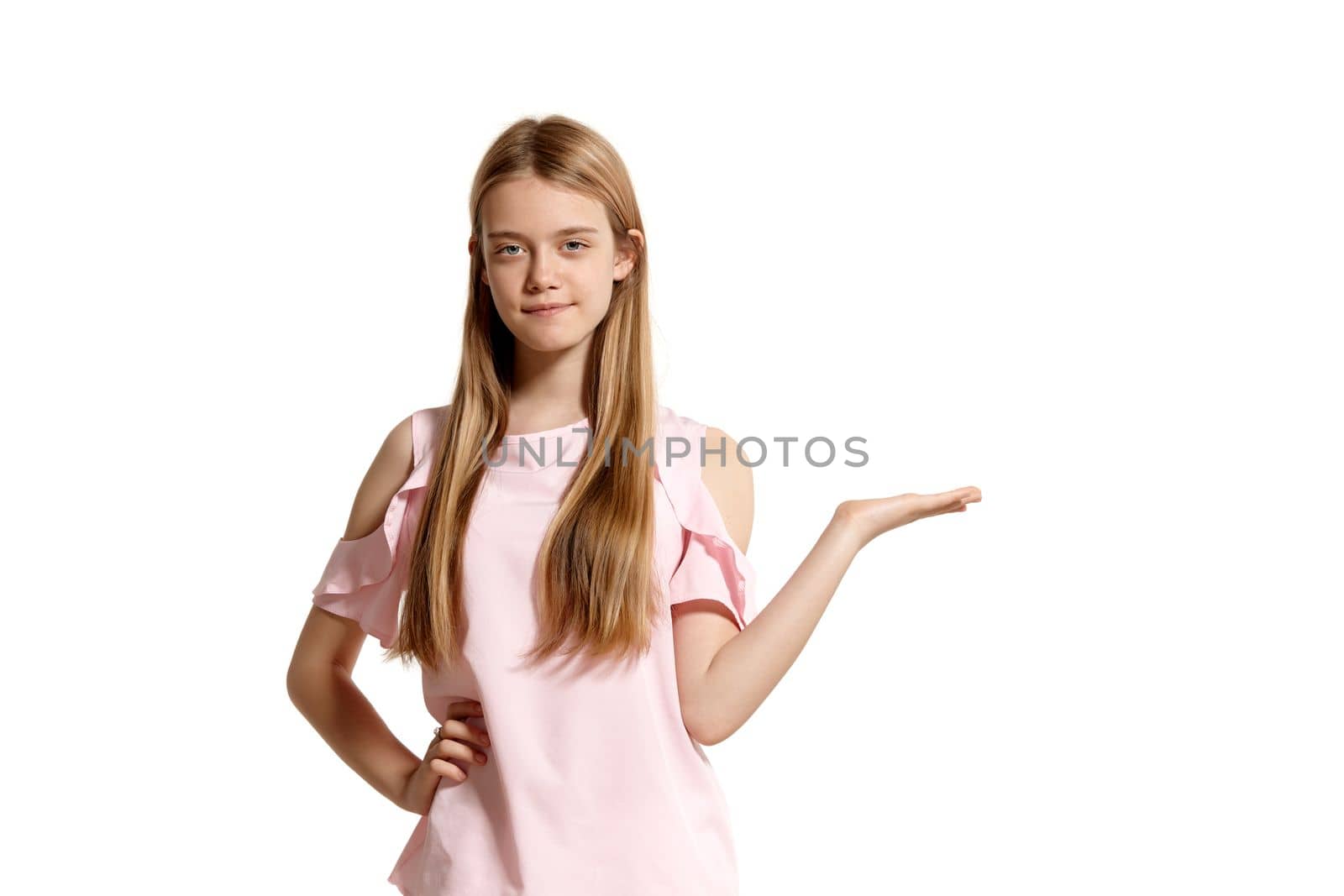 Studio portrait of a lovely blonde teenager in a pink t-shirt isolated on white background in various poses. She expresses different emotions posing right in front of the camera, smiling and holding something.