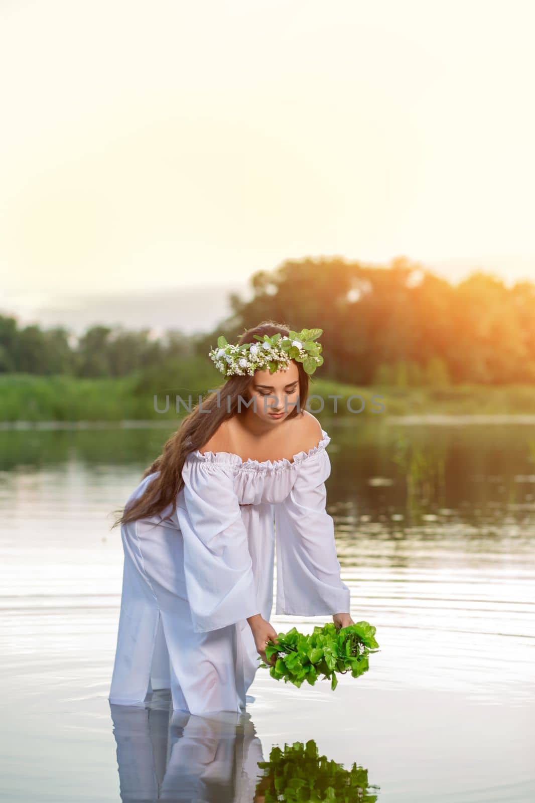 Woman in white dress in the water. Art Woman with wreath on her head in river. Wreath on her head, Slavic traditions and paganism by nazarovsergey