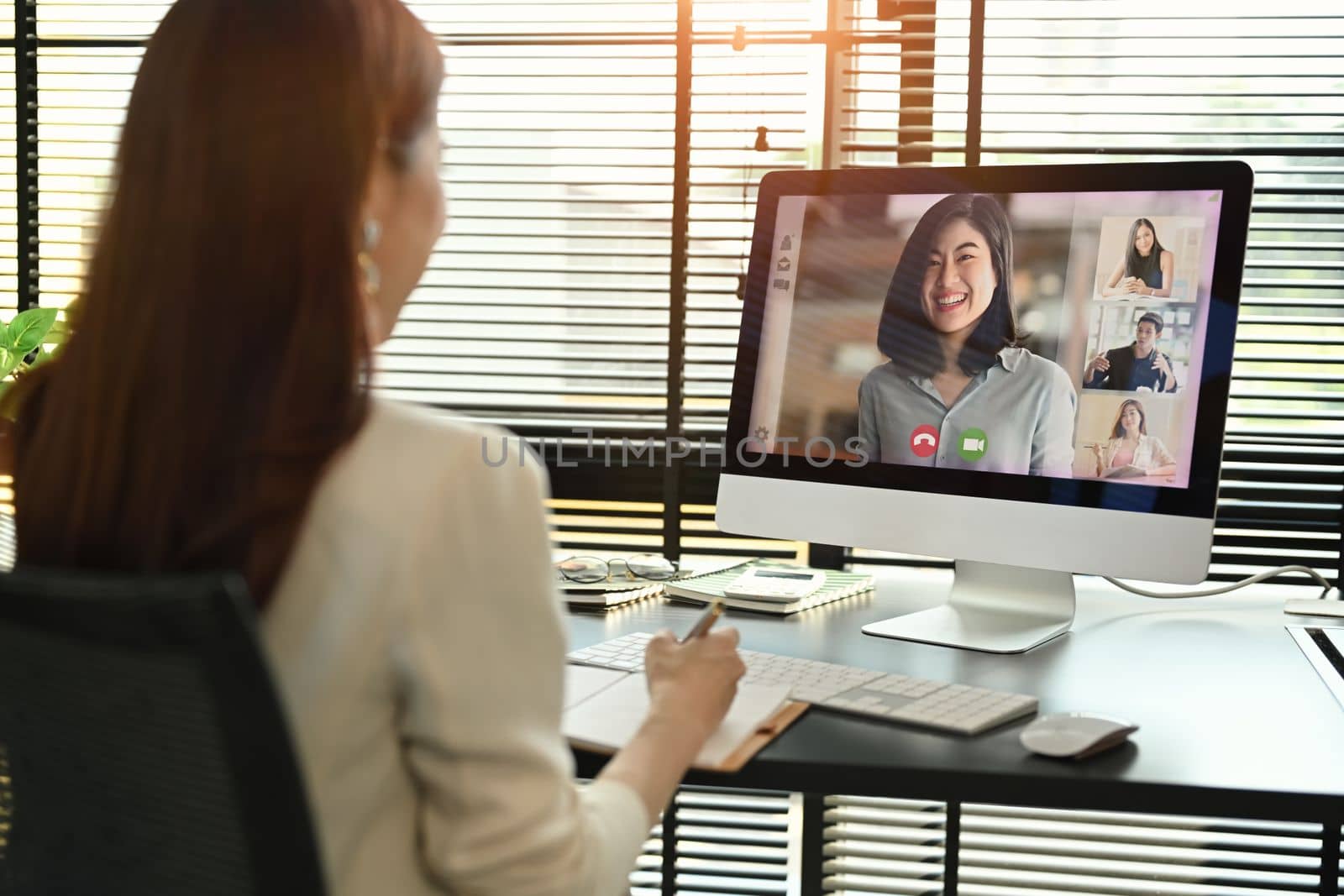 Millennial female manager communicating by video conference on computer. Distant webinar, online negotiations concept by prathanchorruangsak