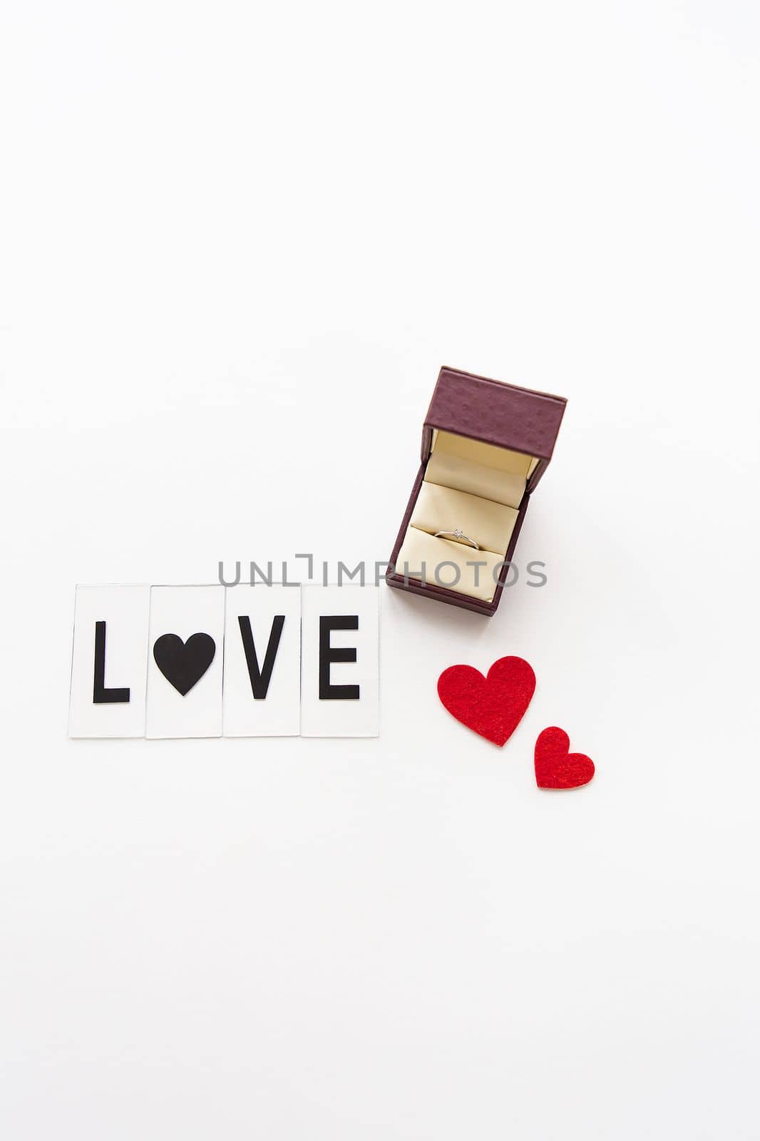 Beautiful inscription love on a white background together with a ring in a box. Marriage proposals