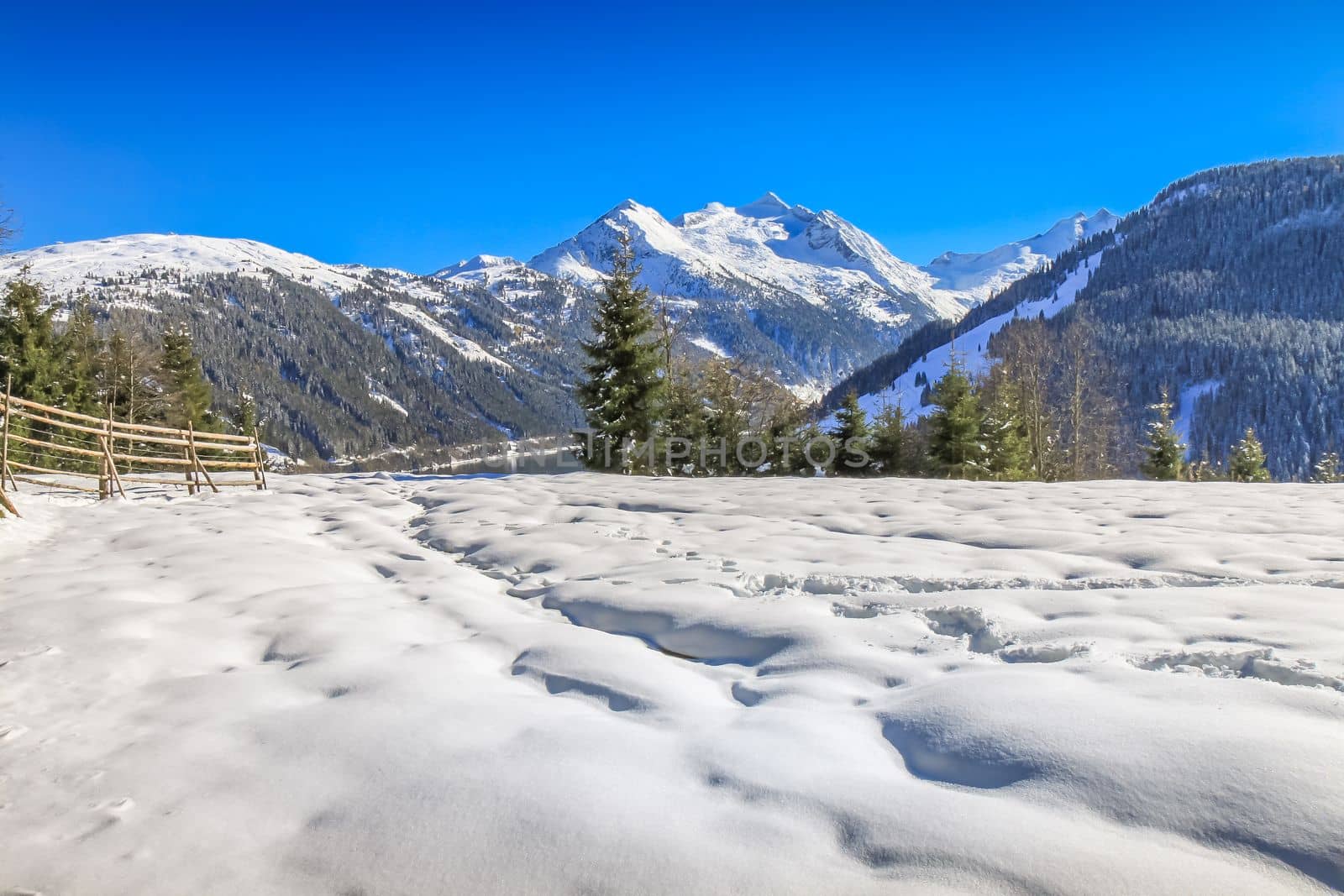Snow ground and snowcapped ountain range in Tyrol near Innsbruck at sunny day, Austria