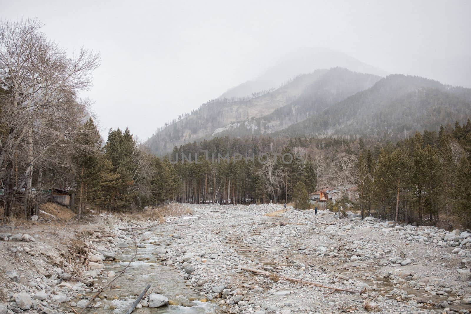 Mirror reflection of Khurai-hobok village in the dense fog against the background of the Sayan Mountains