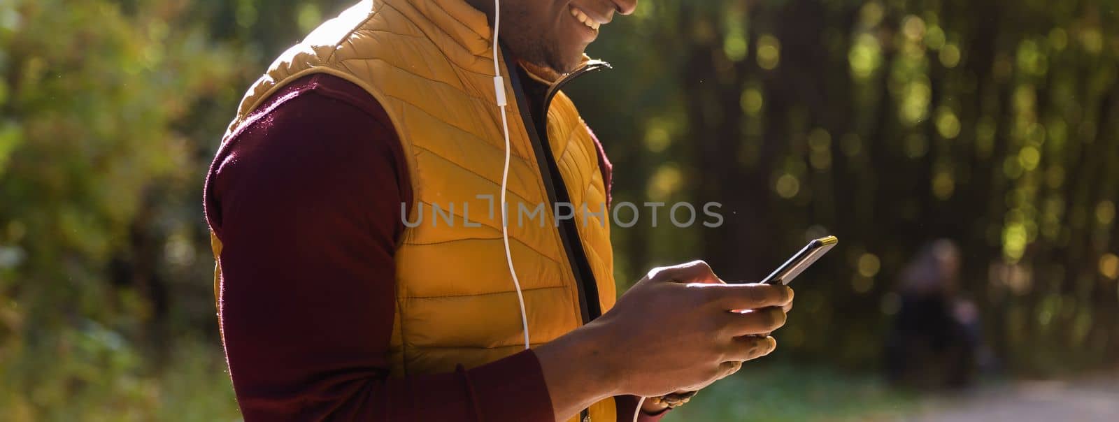 African american man using cellphone applications texting message in messengers, male black hands holding phone working playing game on smartphone, mobile technology lifestyle concept, close up view by Satura86