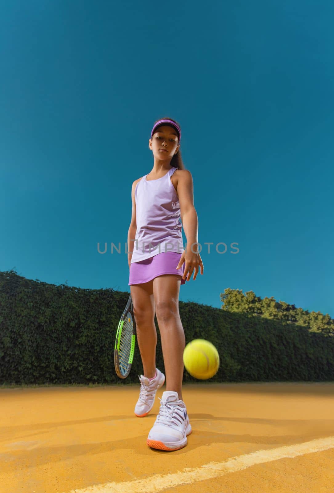 Tennis player. Girl teenager athlete with racket on tennis court. Download photo for advertising in tennis and sports for social networks.