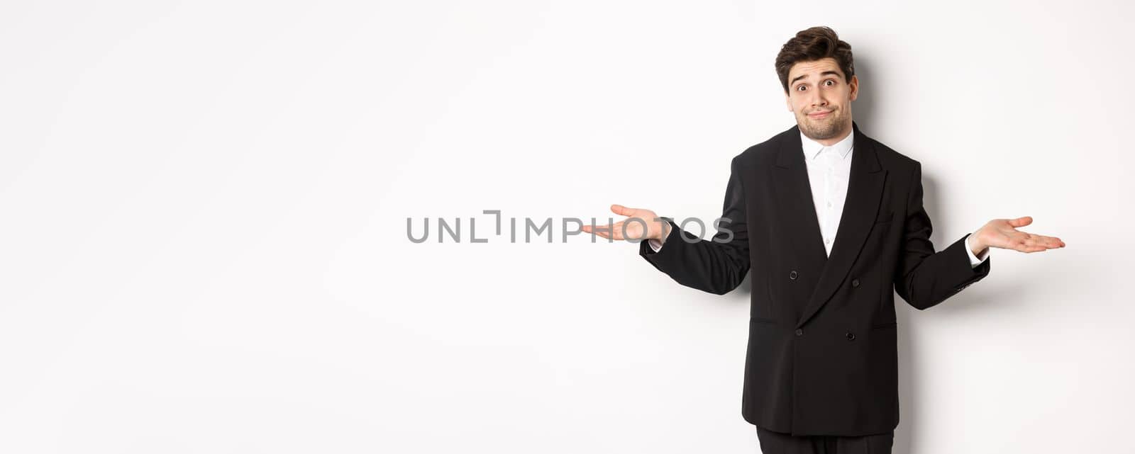 Image of handsome confused man in black suit, shrugging and looking clueless, dont know anything, standing over white background by Benzoix
