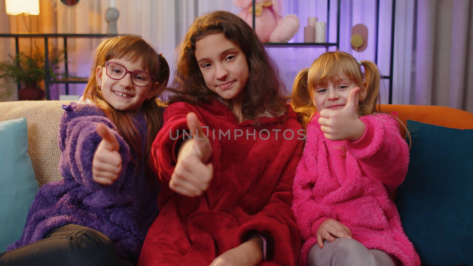 Happy siblings children girls showing thumbs up, like sign positive something good positive feedback by efuror