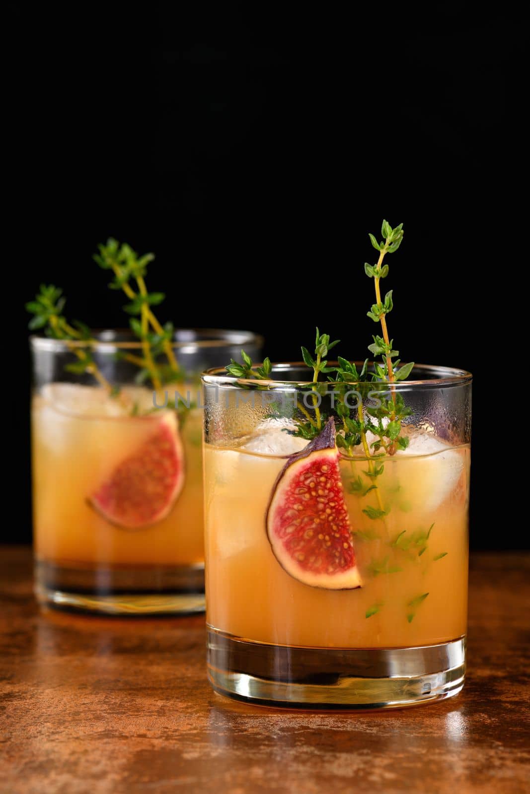 Bourbon Sour cocktail with fig spices, lemon juice and syrup. Easy to make but so delicious. Garnish with figs and thyme.
